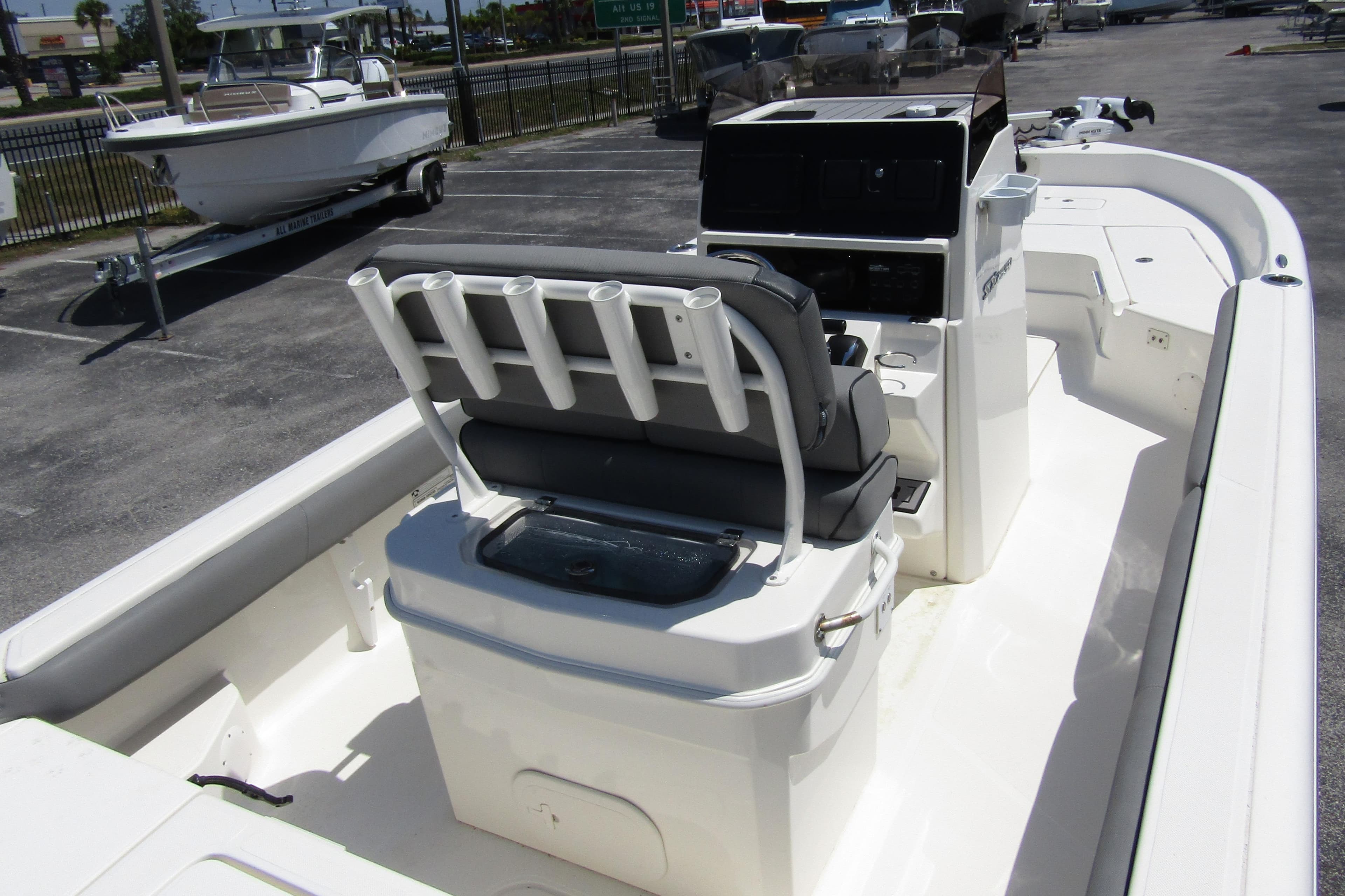 2022 Skeeter SX2550 Fish boat interior with seating and console, parked outdoors.