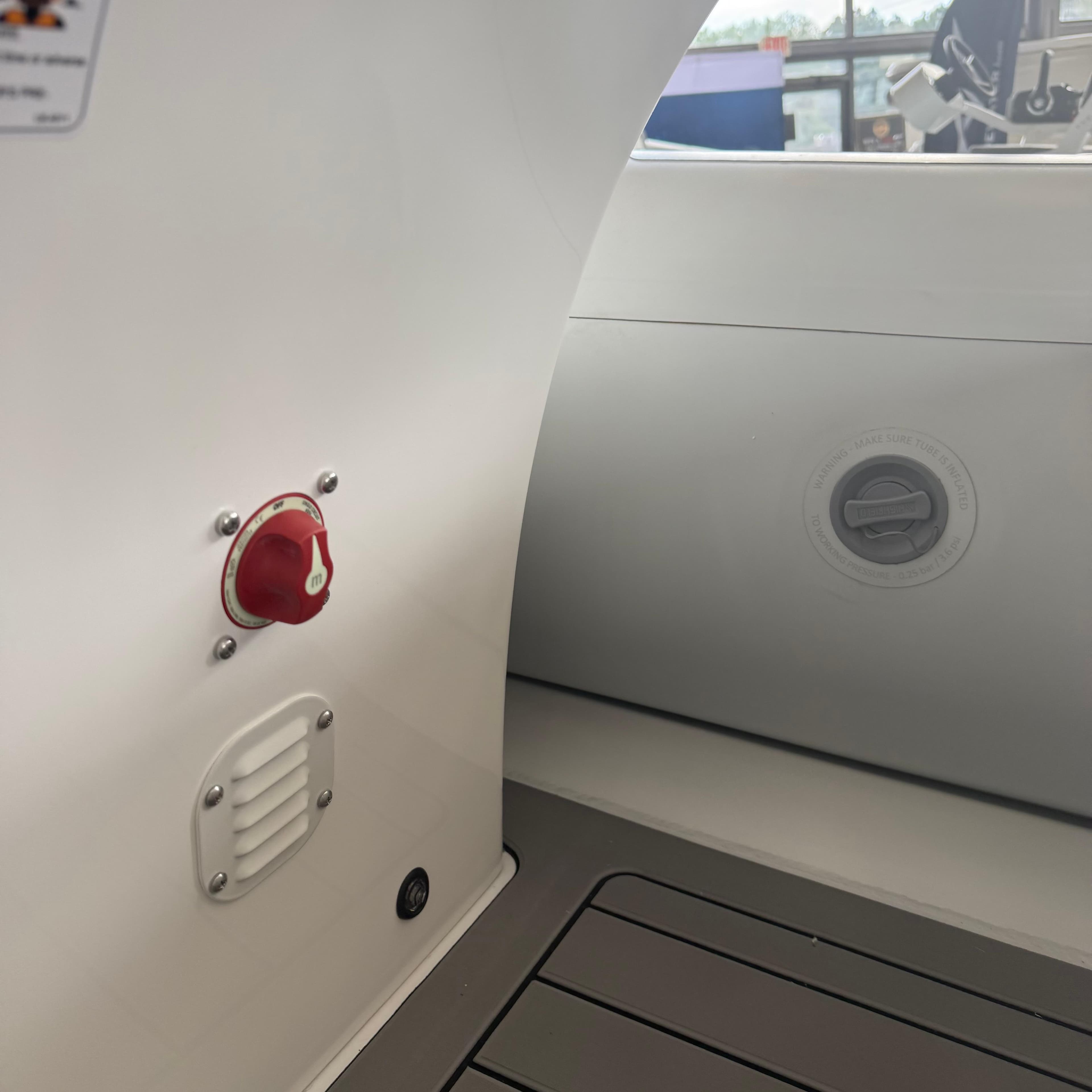 Interior view of a 2025 Highfield Sport 390 boat, featuring control panel and seating area.