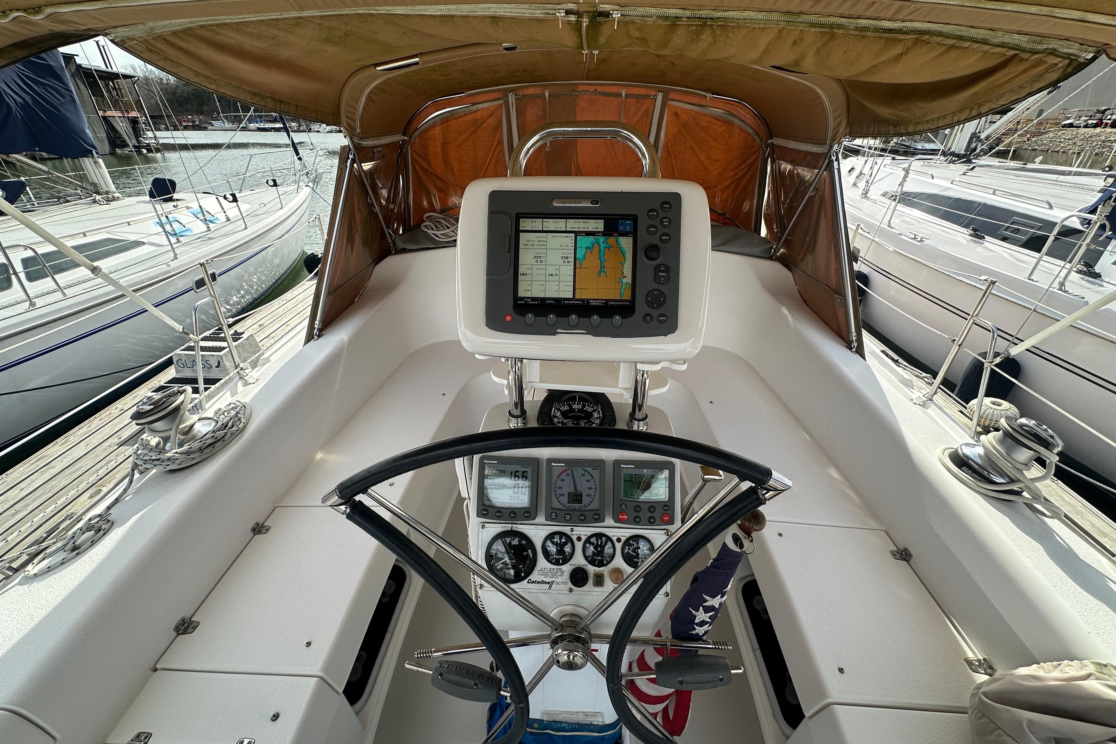 Cockpit of 2006 Catalina 387 sailboat with navigation equipment and steering wheel.