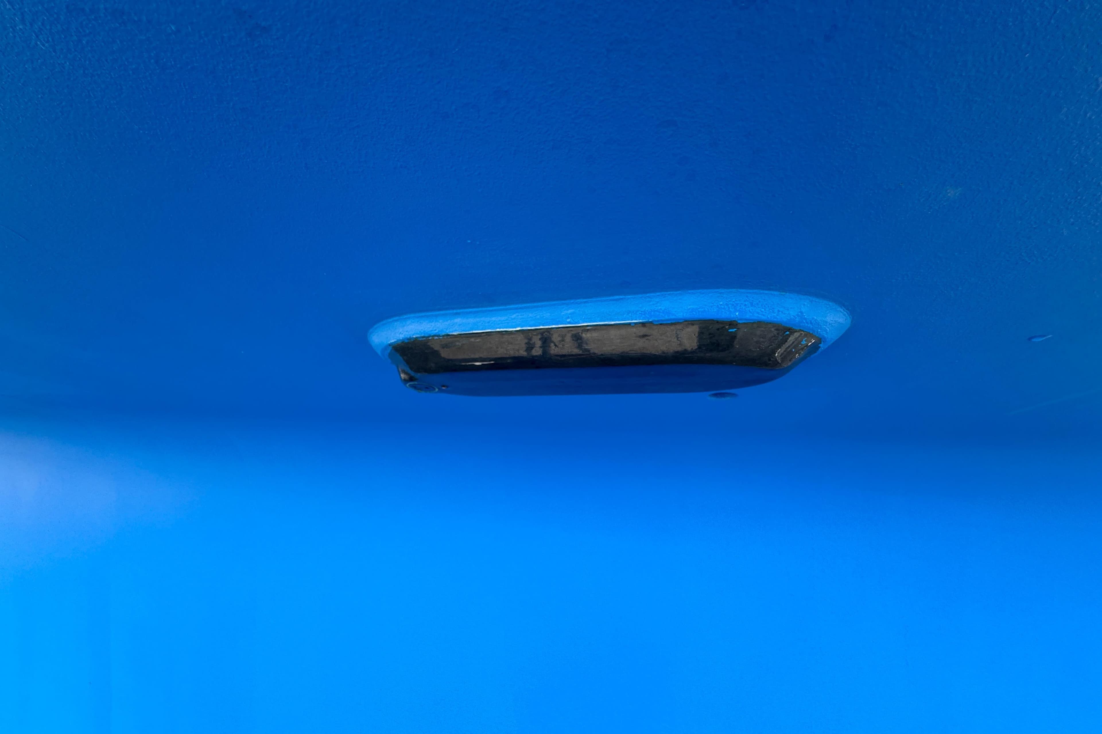 Blue hull of 2012 Hylas 49CC boat with underwater fitting.