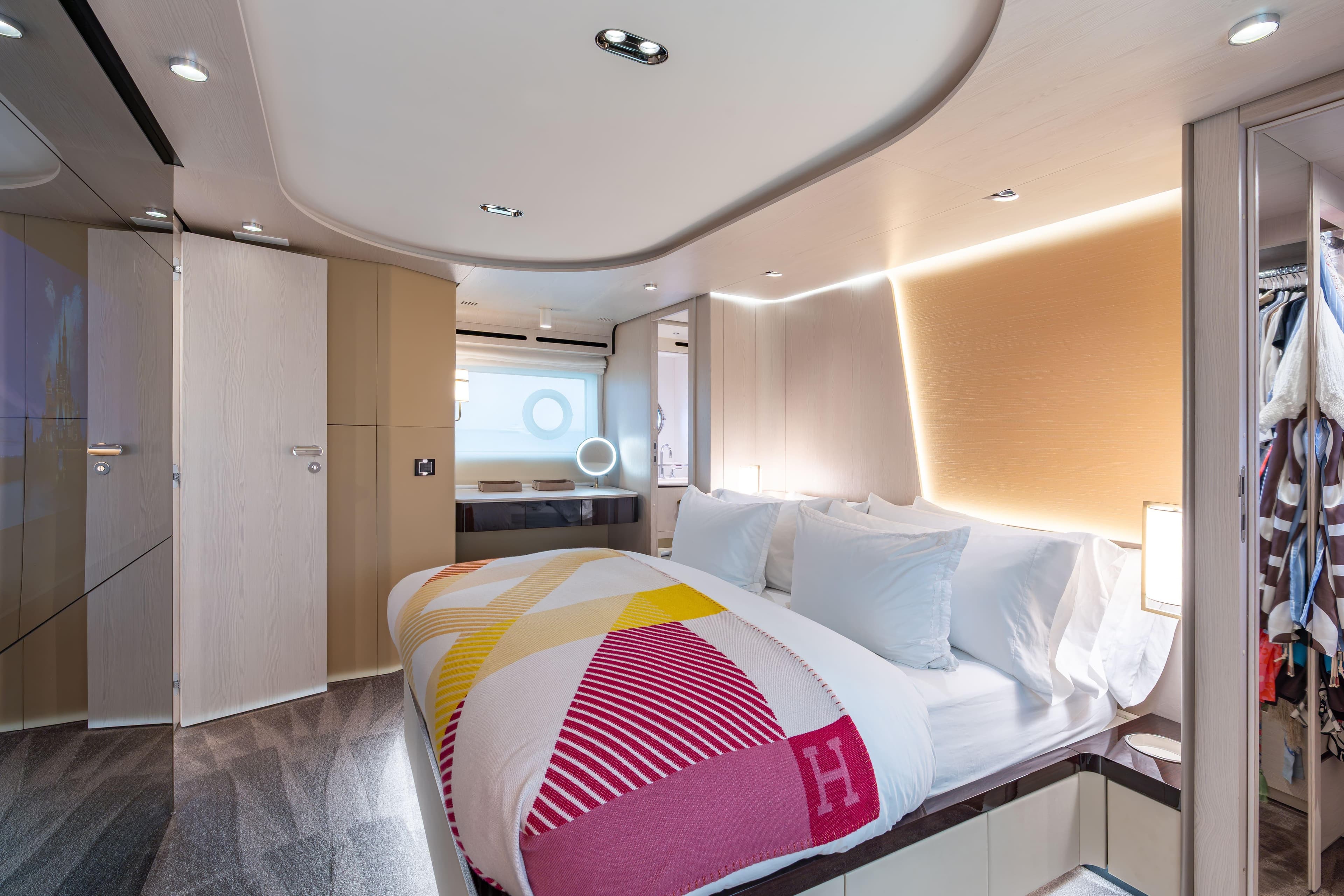 Luxurious bedroom interior of 2022 Azimut 78 yacht, featuring modern design and elegant lighting.
