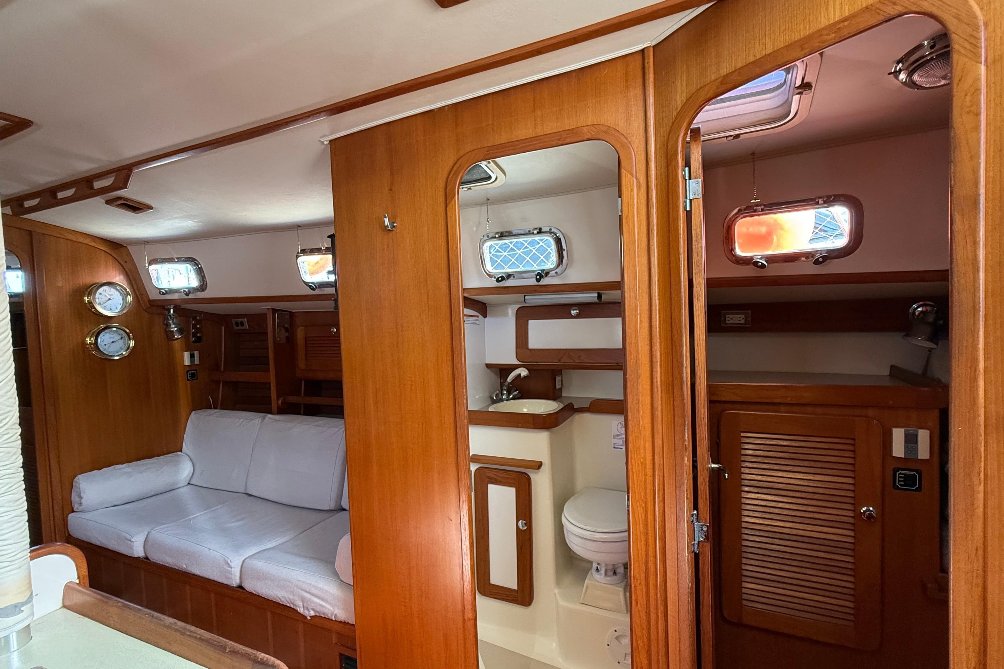 Interior of 2004 Caliber 40LRC yacht with wooden finish and cozy seating area.