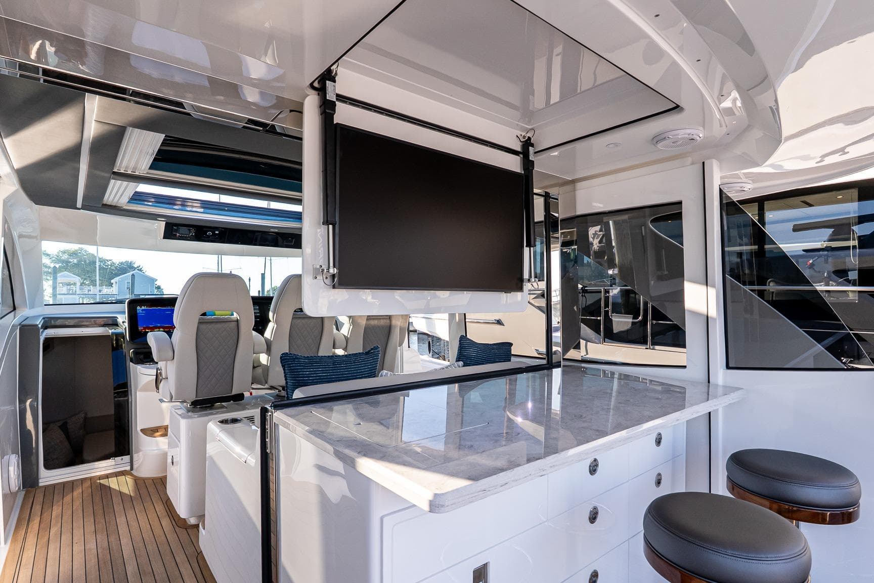 Luxurious interior of 2026 Valhalla V-55 Sport Yacht with modern seating and entertainment system.