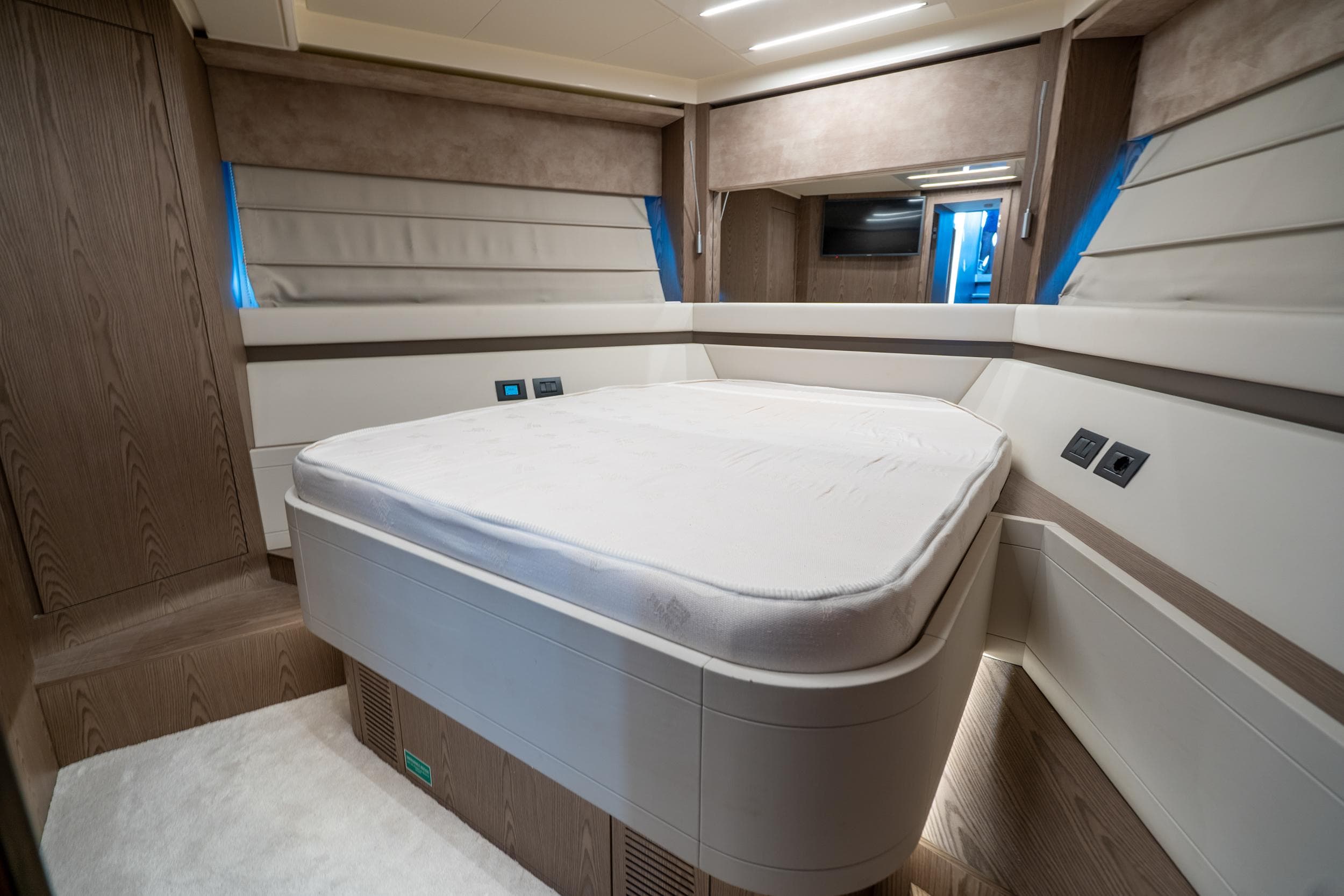 Luxurious bedroom interior of 2021 Ferretti Yachts 550, featuring modern design and ambient lighting.