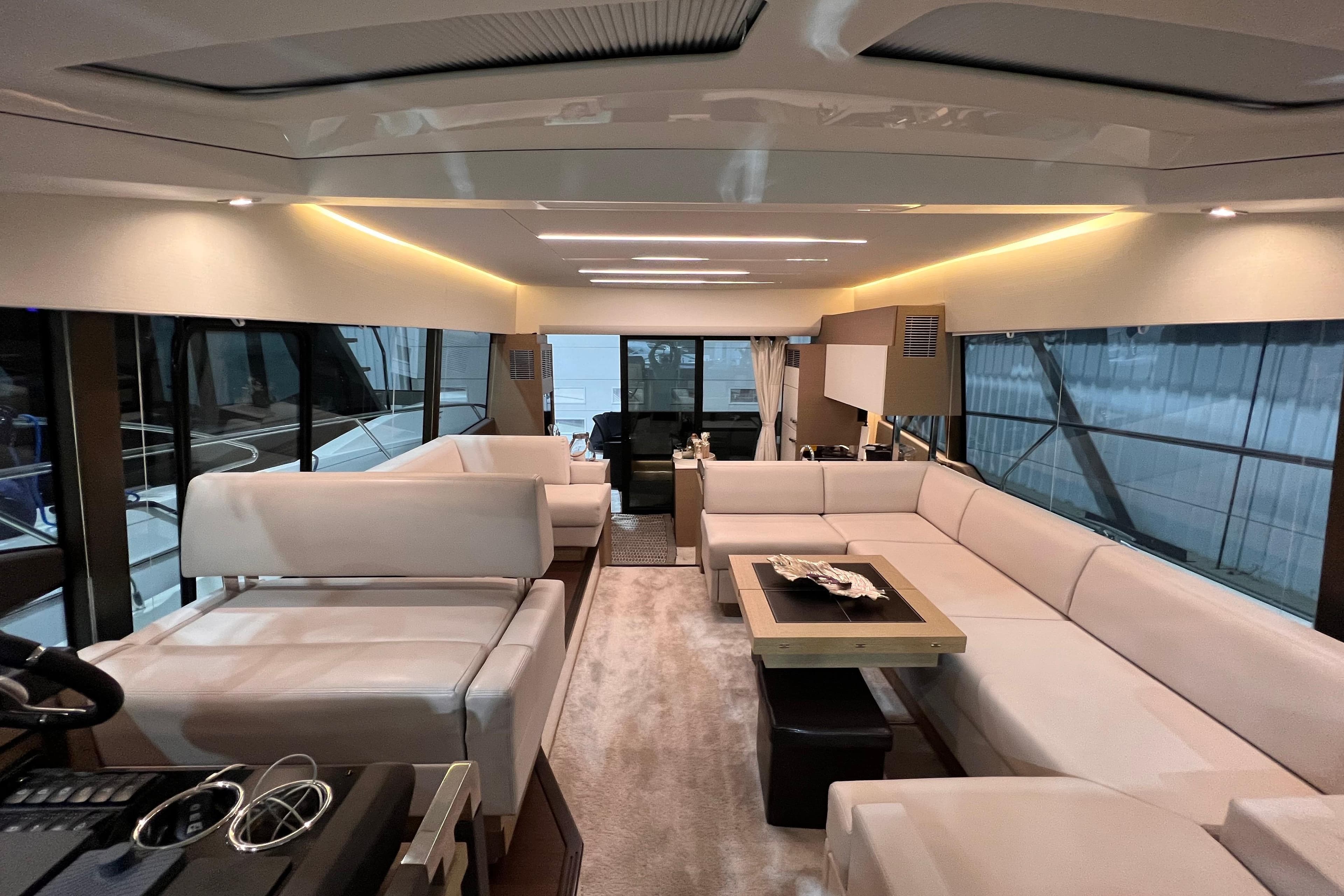 Luxurious interior of a 2018 Prestige 520 yacht with elegant white seating and modern design.