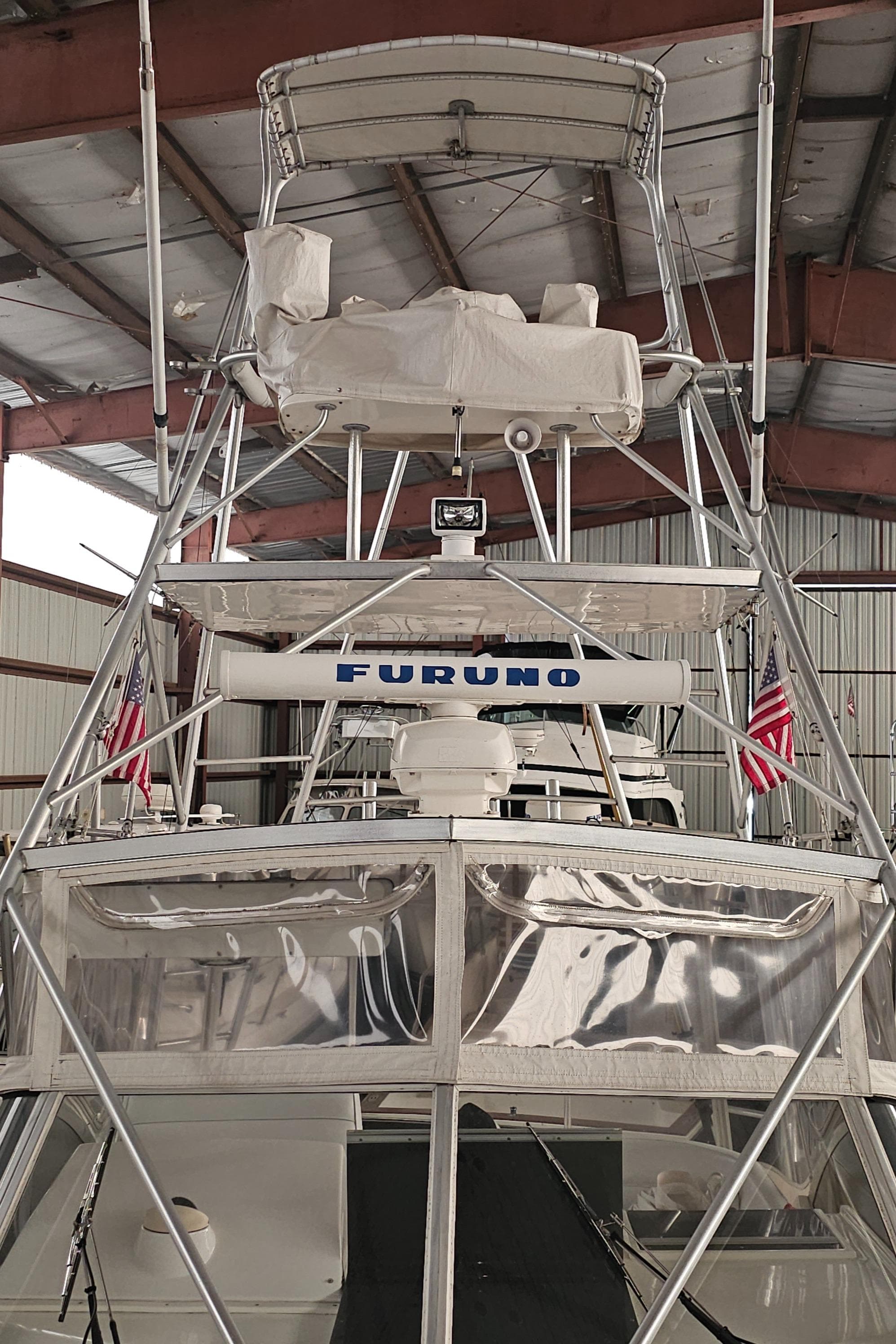 1994 Blackfin 33 Combi boat with tower and Furuno equipment in a storage facility.