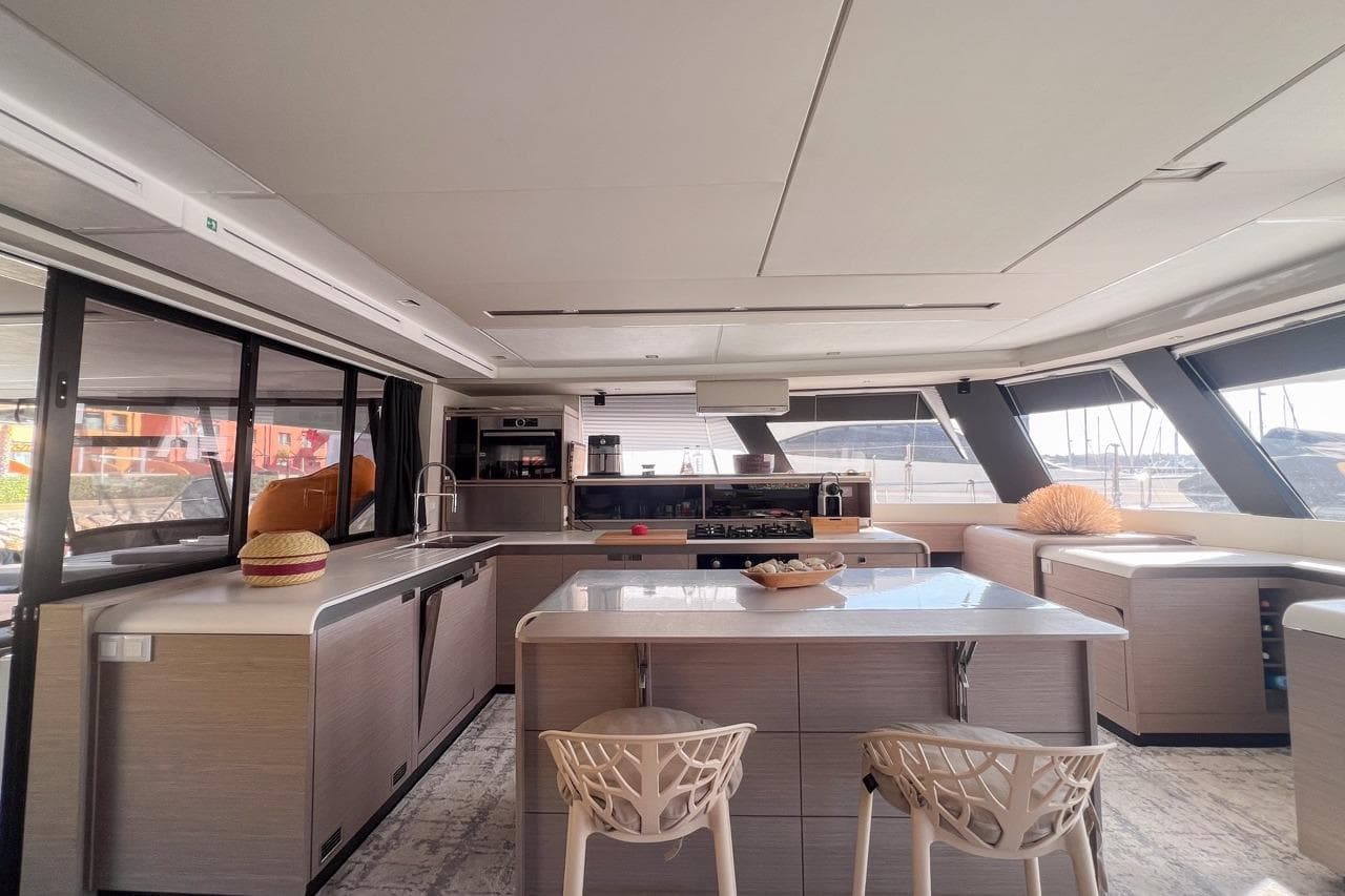 Luxurious interior of 2023 Fountaine Pajot Samana 59 yacht with modern kitchen design.