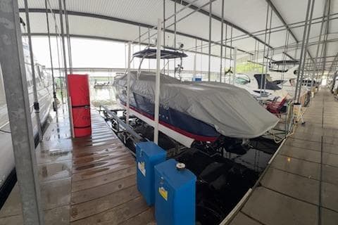 Covered 2007 Cobalt 343 boat docked in a marina with protective canopy.