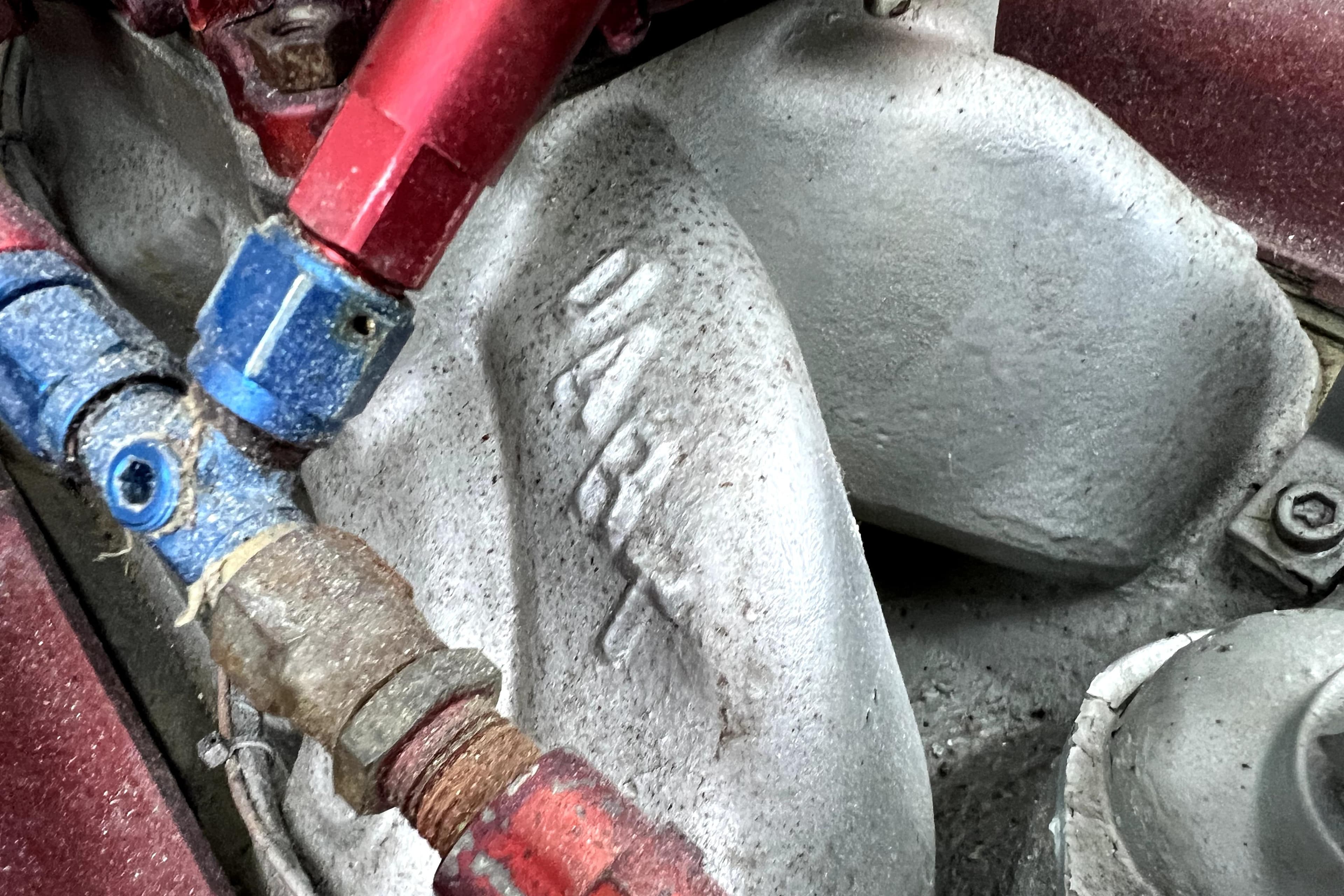 Close-up of 1989 Cigarette Cafe Racer 35 engine components with red and blue fittings.