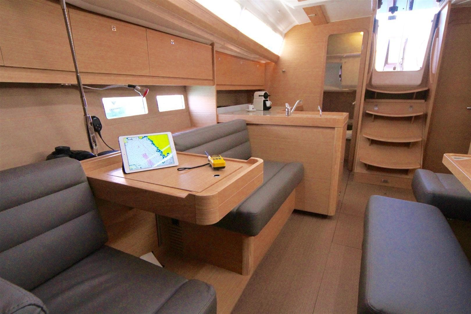 Interior of 2016 Dufour 412 Grand Large yacht with modern seating and navigation equipment.
