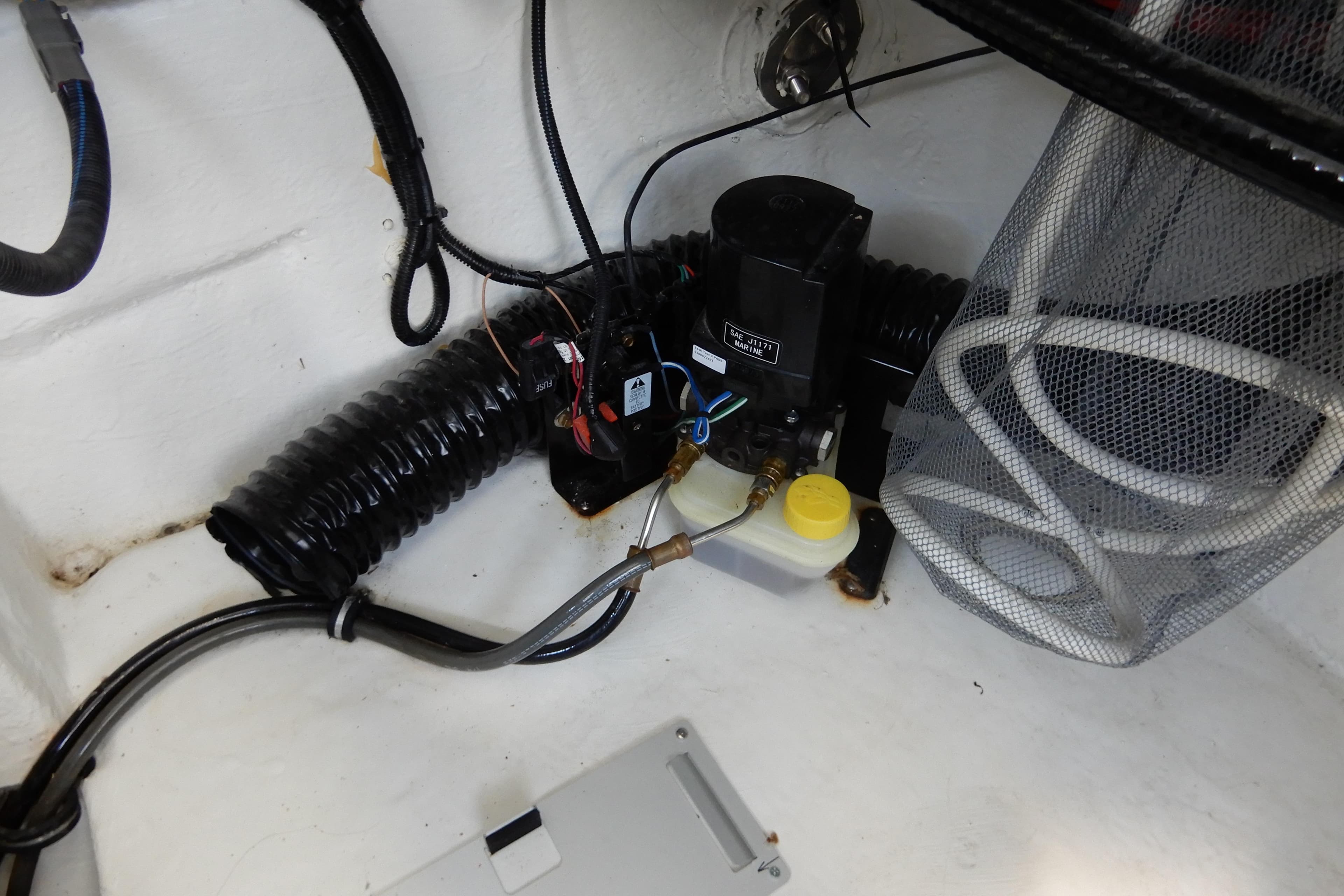 Engine compartment of 2022 Monterey 295 Sport Yacht with wiring and components.