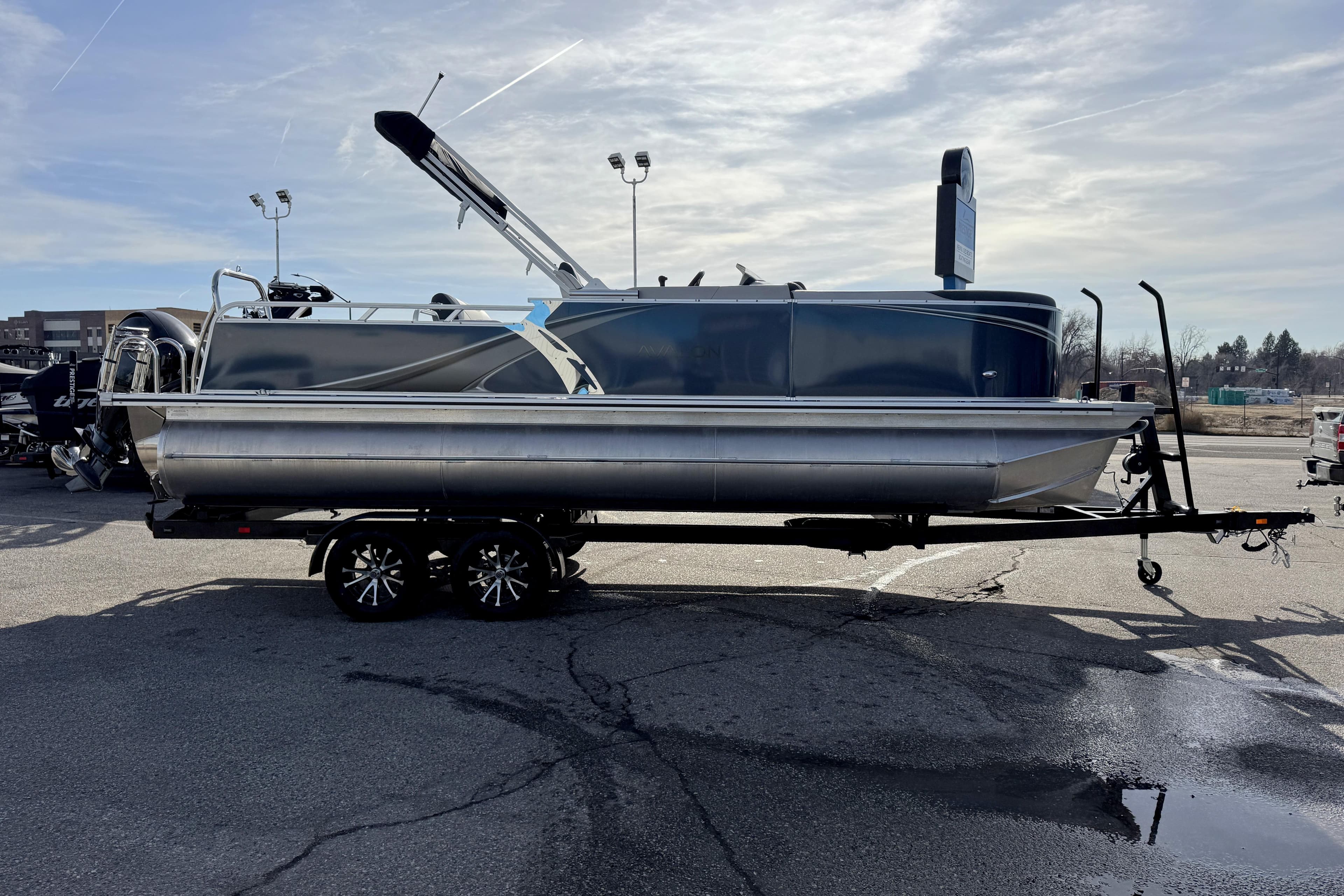 2026 Avalon 2385 25 LSZ VRB pontoon boat on trailer under cloudy sky.