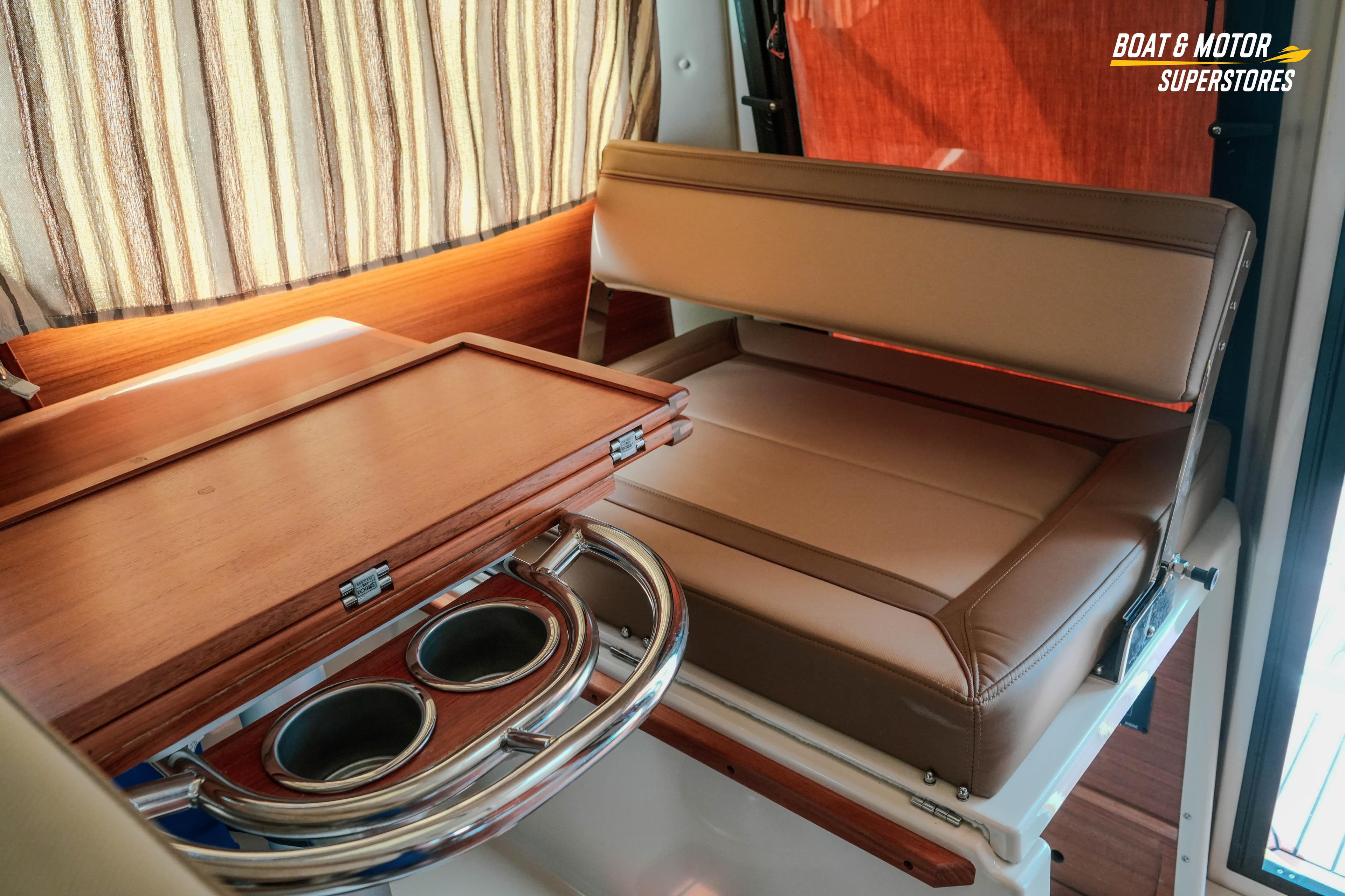 2024 Ranger Tugs R-27 interior with foldable table and cup holders.