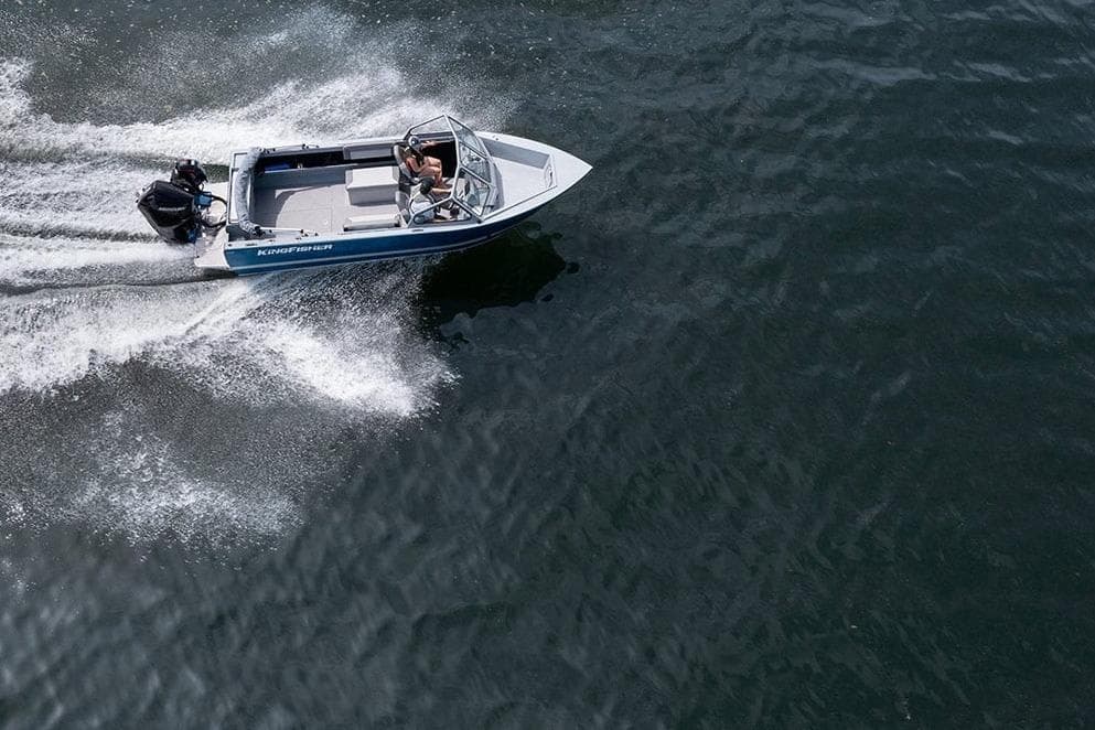 Aerial view of 2026 KingFisher 2025 Escape boat speeding on water.