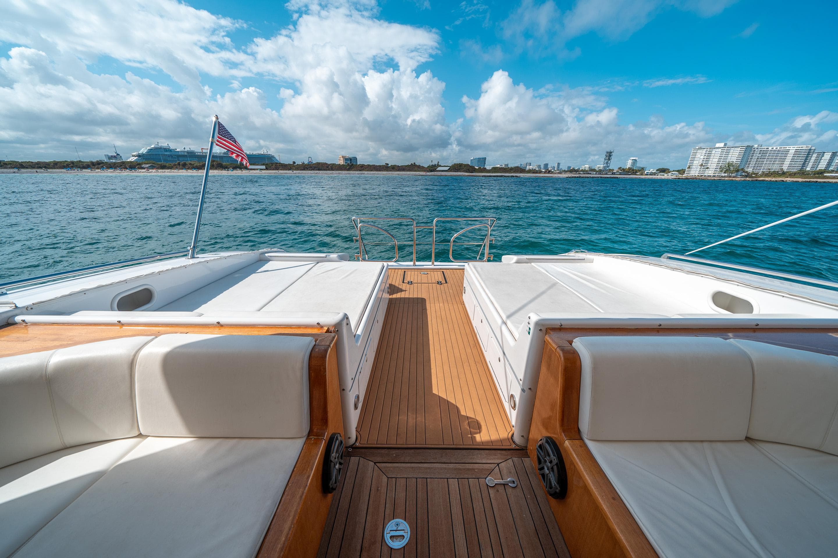 Luxury Mangusta 80 yacht deck, 2001 model, with ocean view and clear skies.