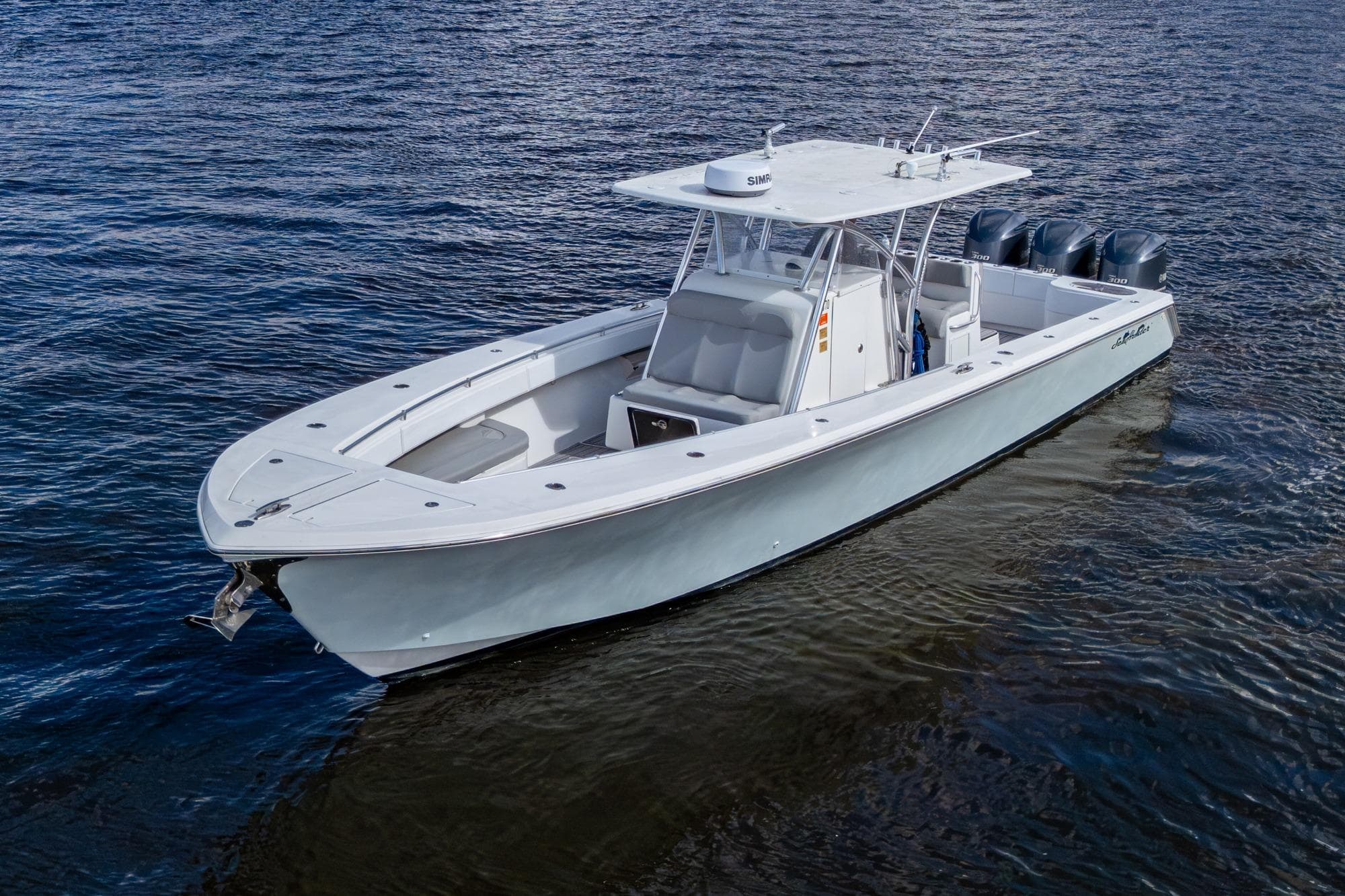 2015 SeaHunter 37 Tournament boat on calm water, featuring sleek design and triple engines.