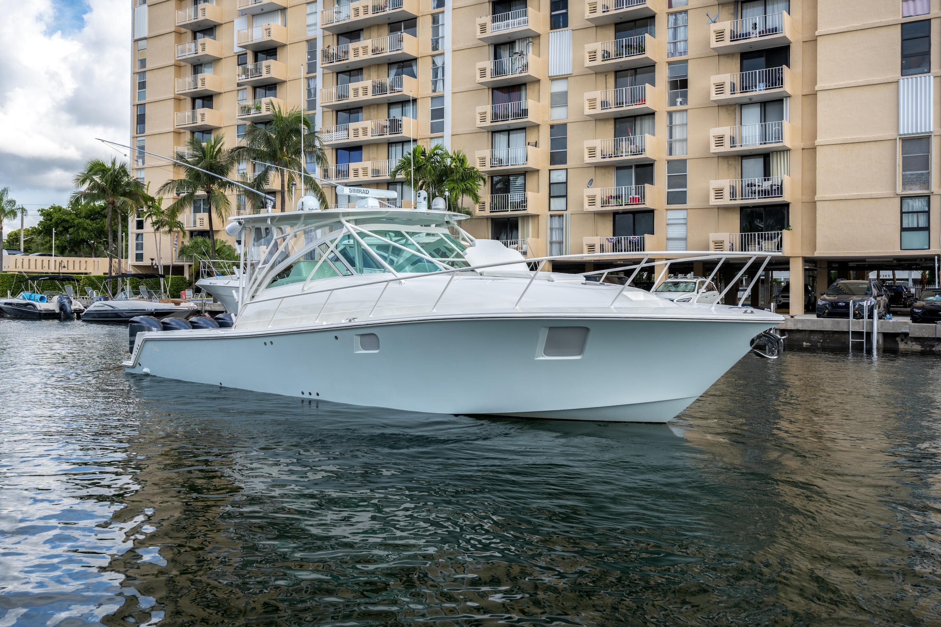 2011 SeaVee 430 Sport Express boat docked near waterfront apartments.