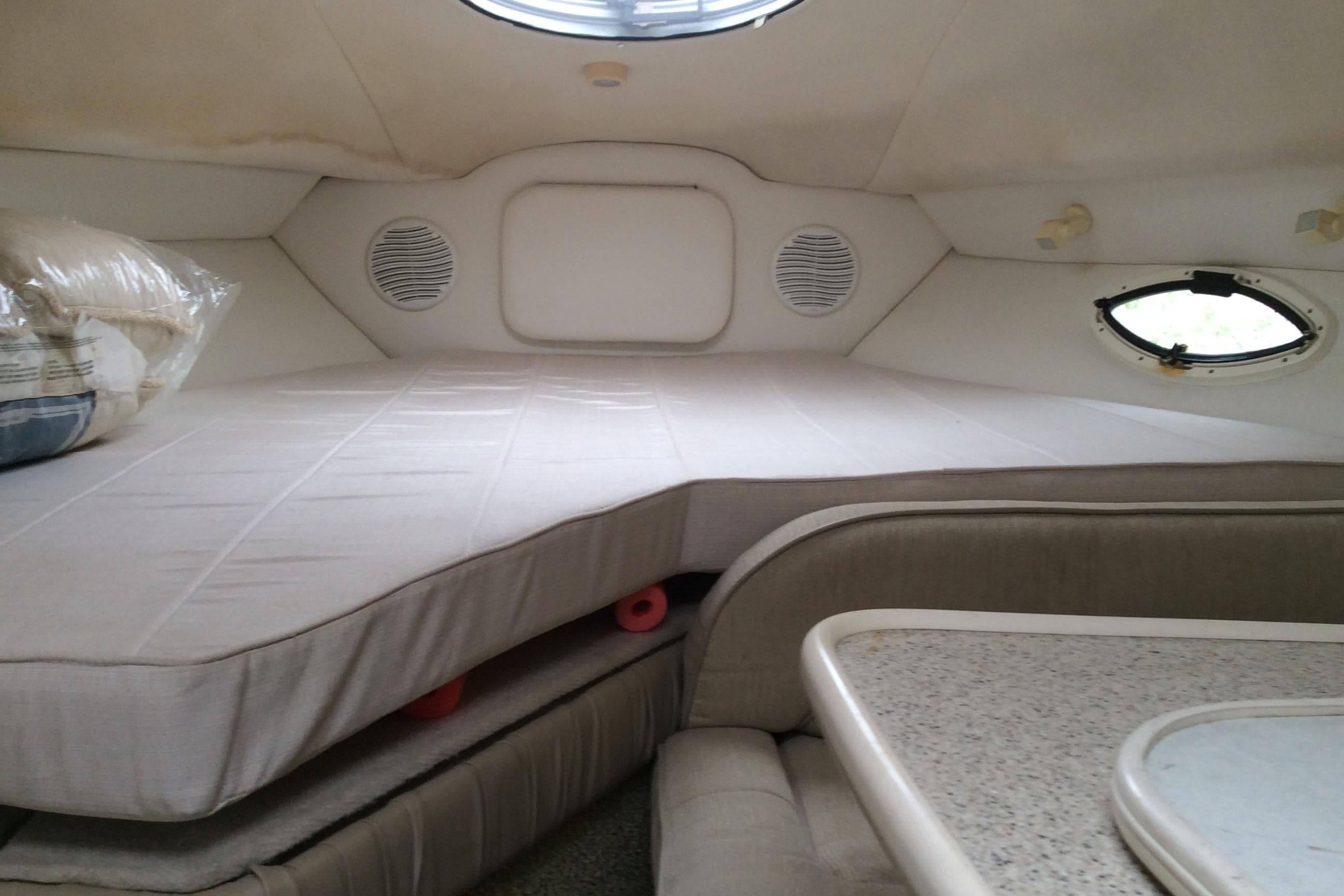 Interior cabin of 2000 Maxum 2800 SCR boat with bed and seating area.