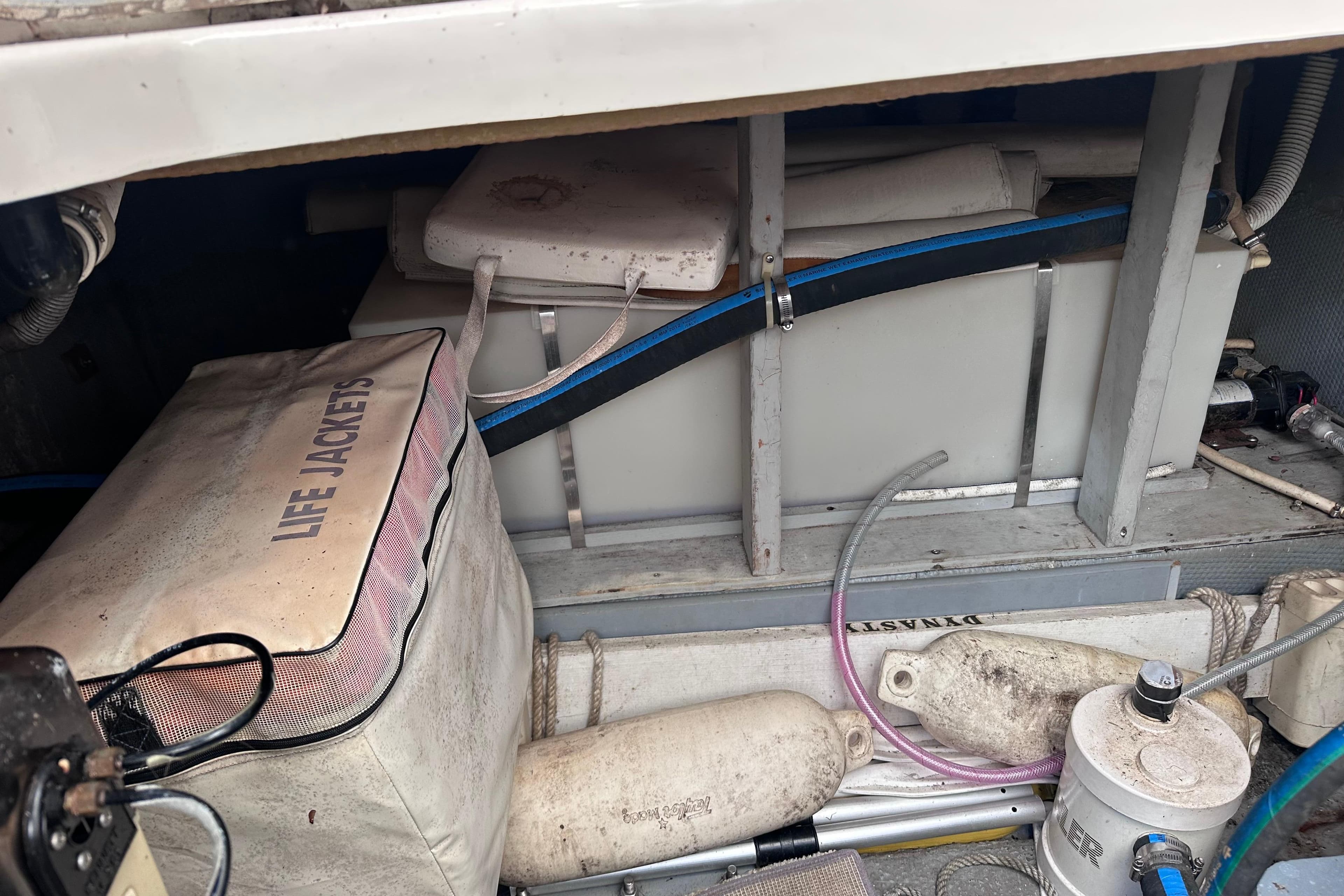 Storage area of 1988 Silverton 37 Convertible with life jackets and equipment.