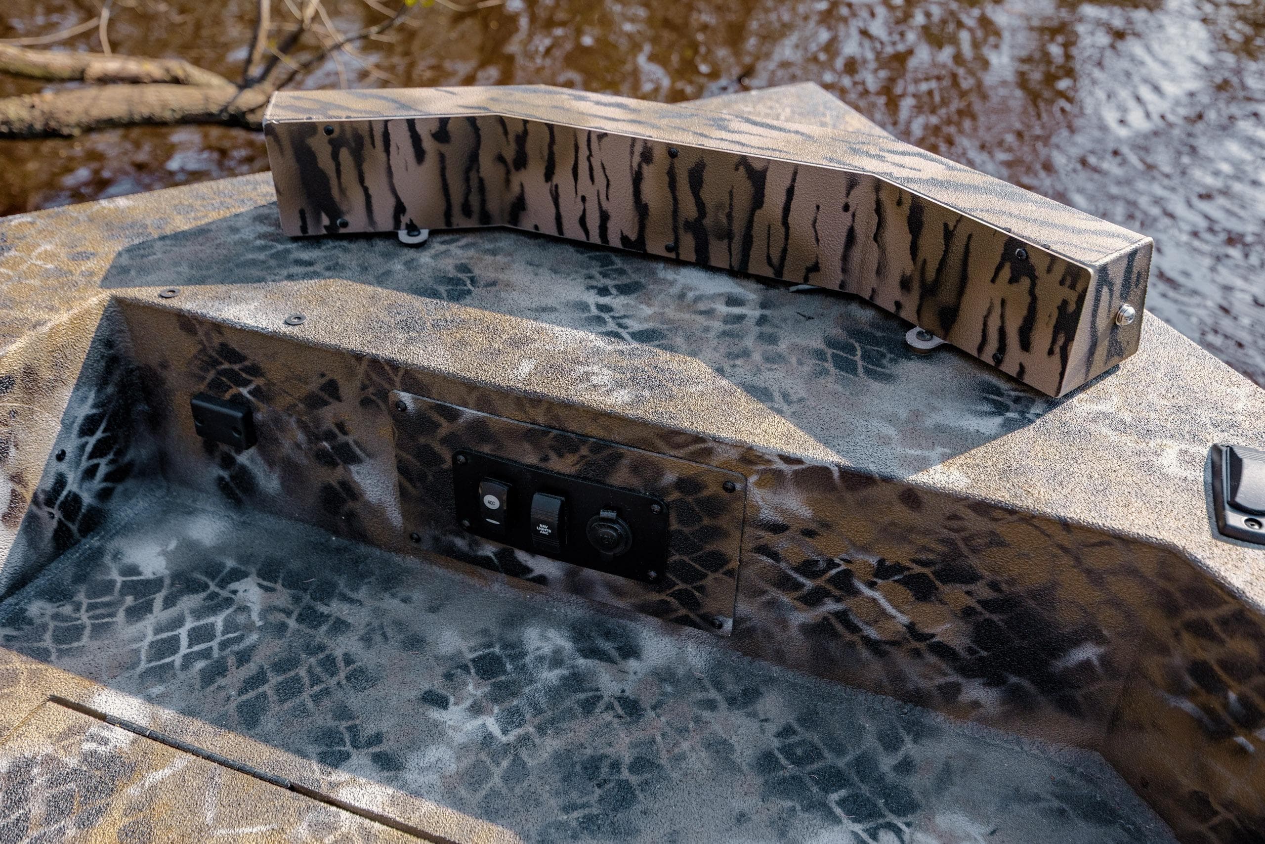 Camouflage-patterned deck of 2026 Excel 183 Tomahawk boat with control panel.