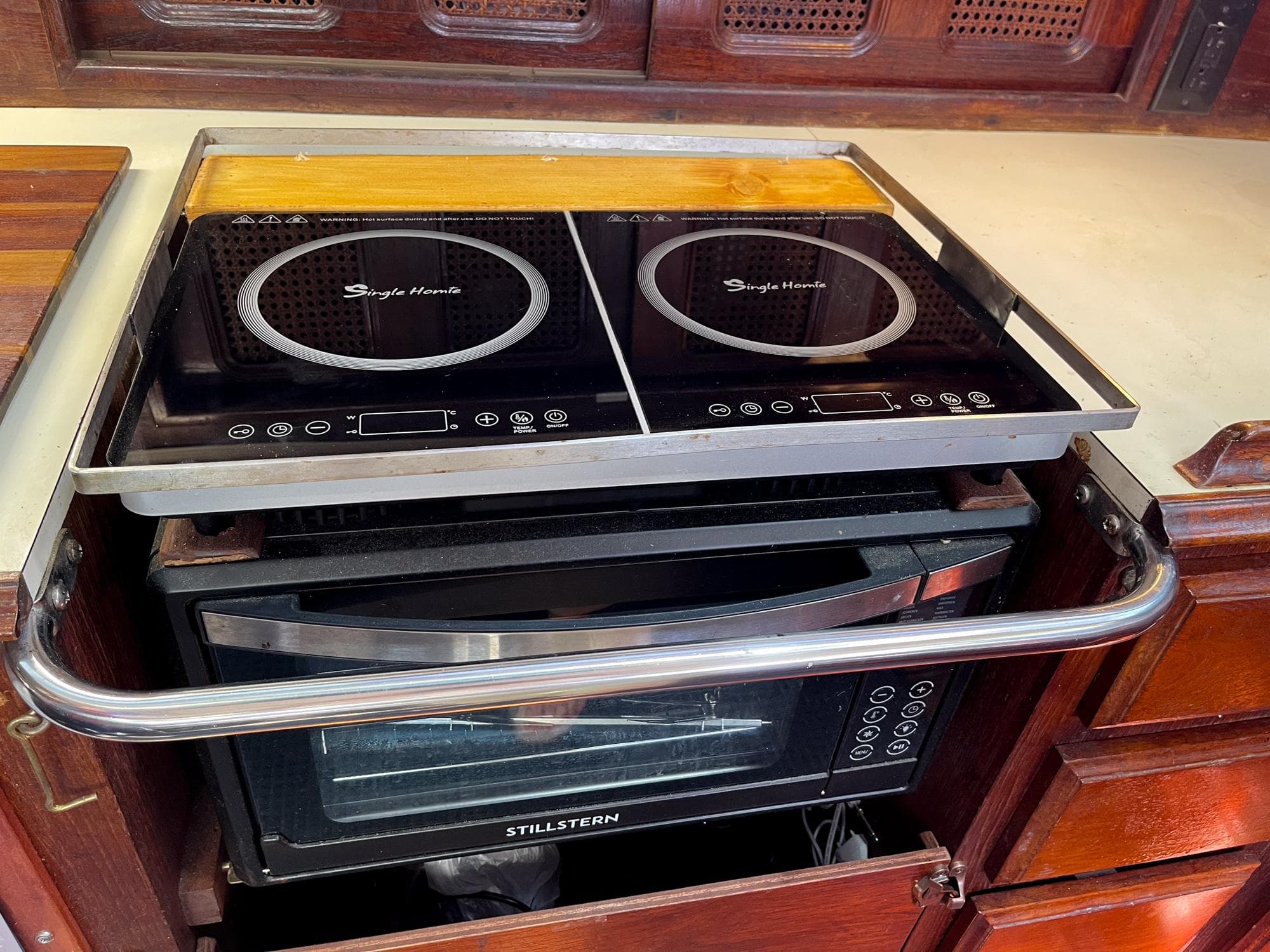 Induction cooktop and oven in 1983 Islander Freeport yacht kitchen.