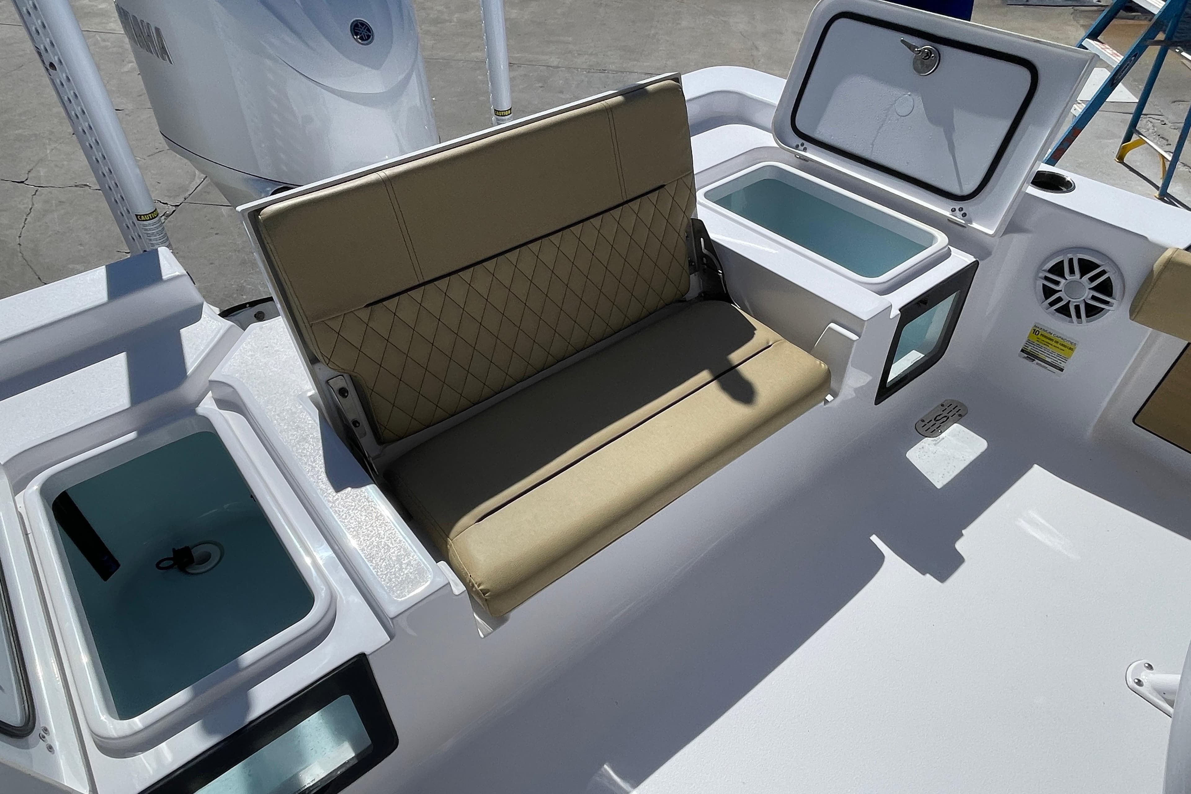 2024 Sportsman Masters 247 Bay Boat interior with cushioned seating and storage compartments.