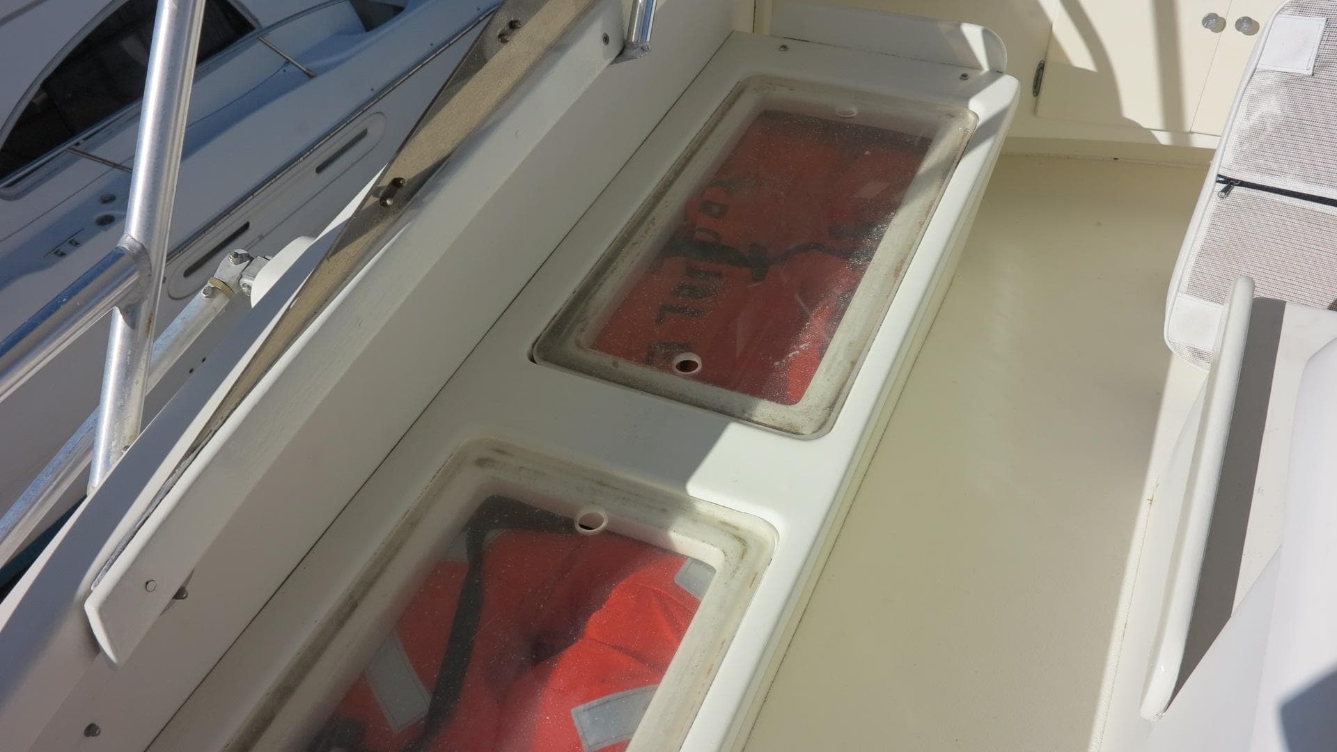 1986 Post Sportfisher boat with life jackets stored under clear compartments.