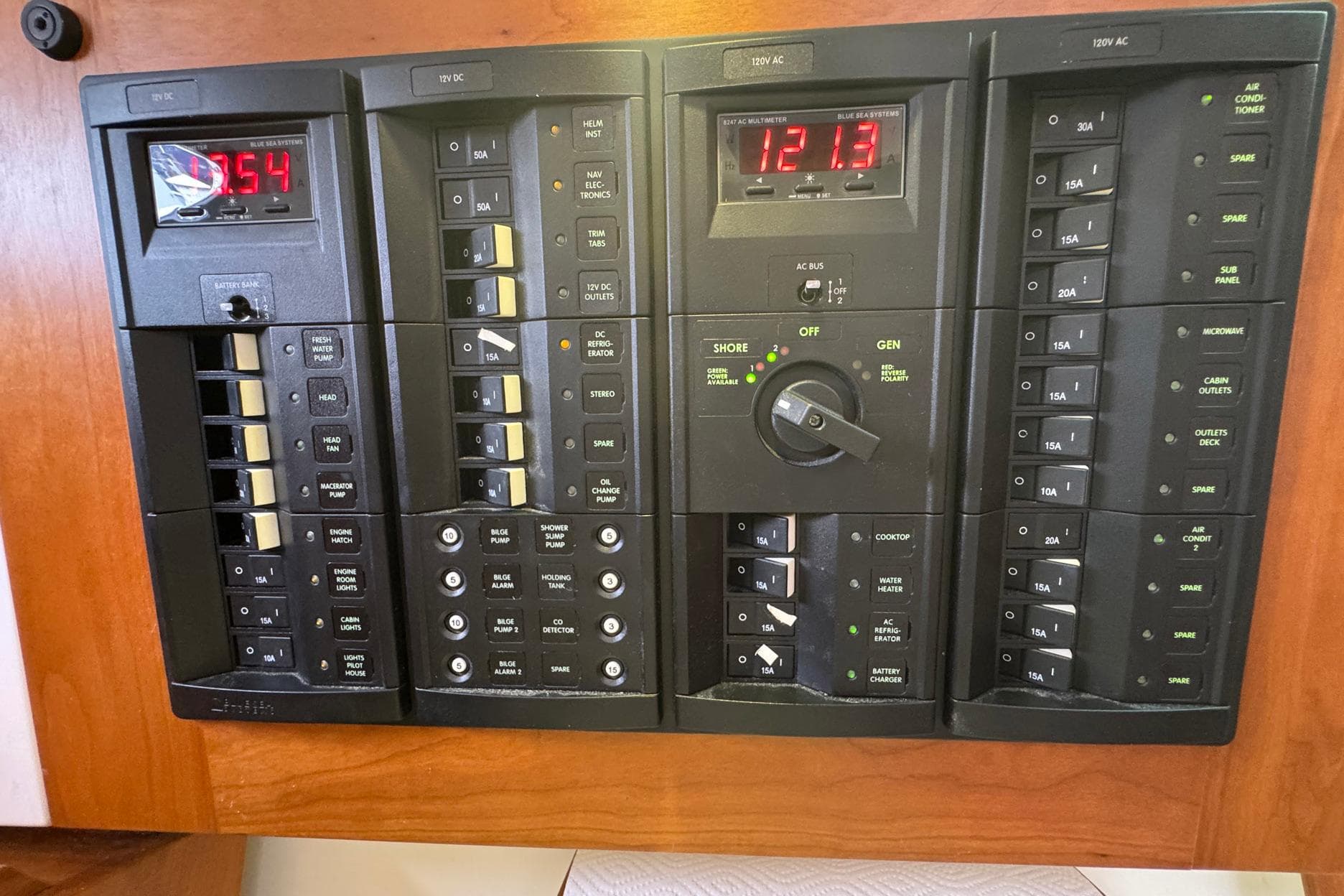 Electrical control panel on a 2013 Back Cove 30 boat, featuring various switches and meters.