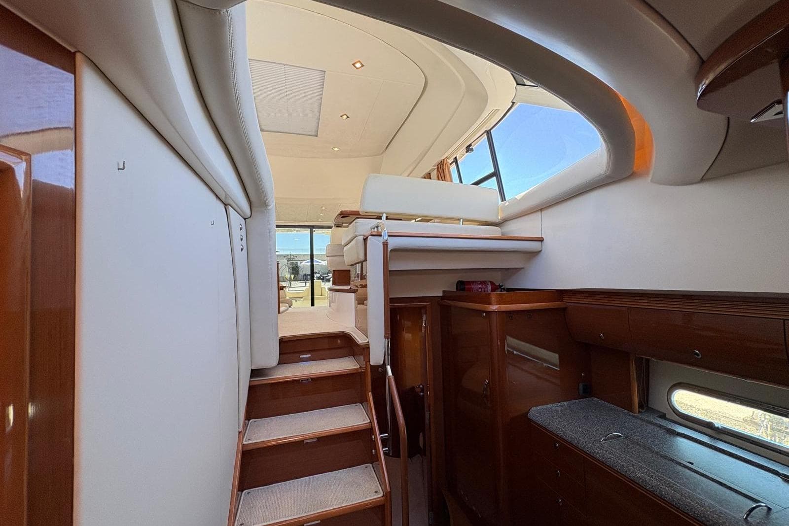 Interior view of 2010 Jeanneau Prestige 50 yacht, featuring elegant wood finishes and modern design.