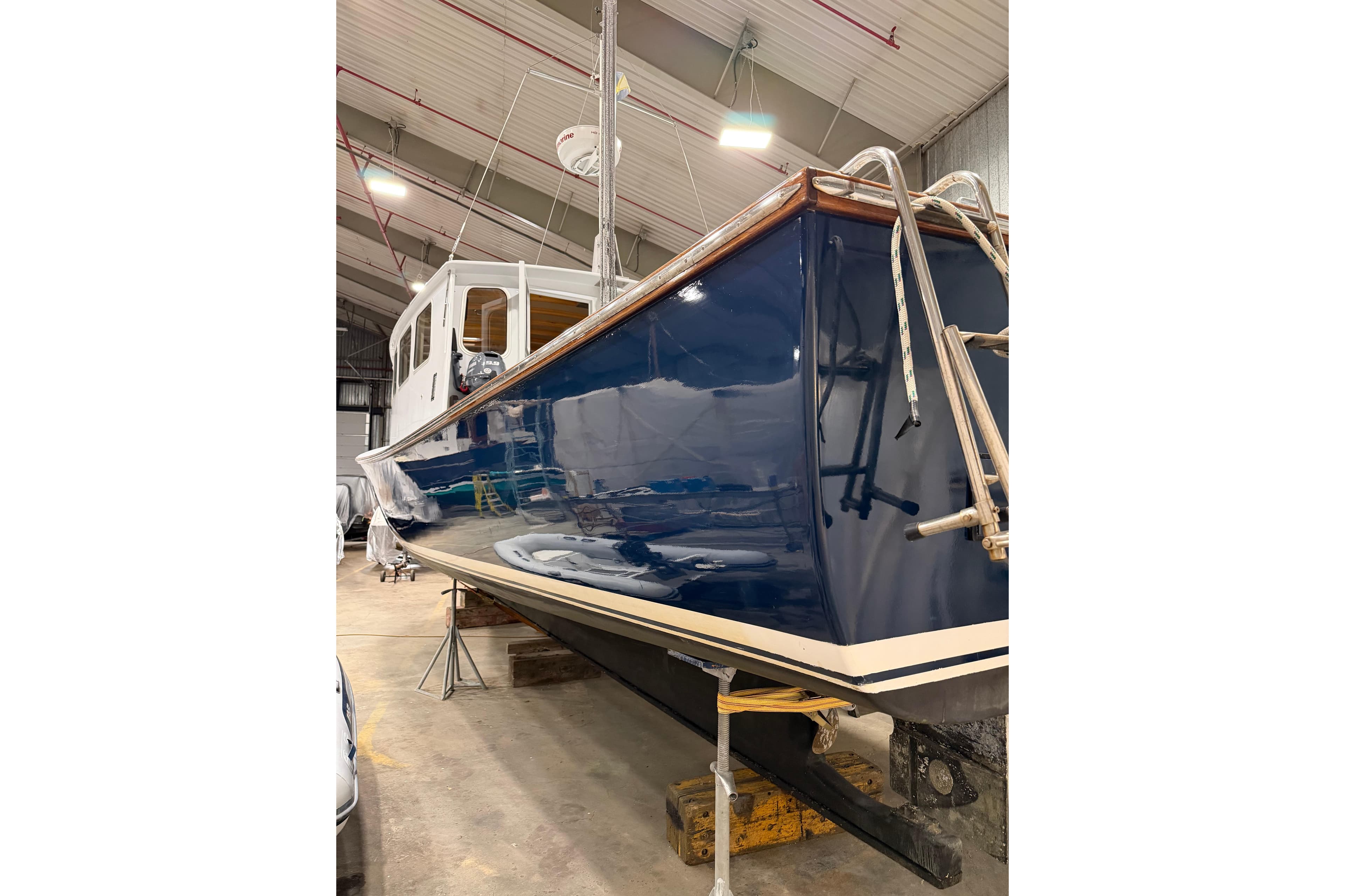 2022 Covey Island 38 Lobster Yacht in a boatyard, showcasing sleek blue hull.