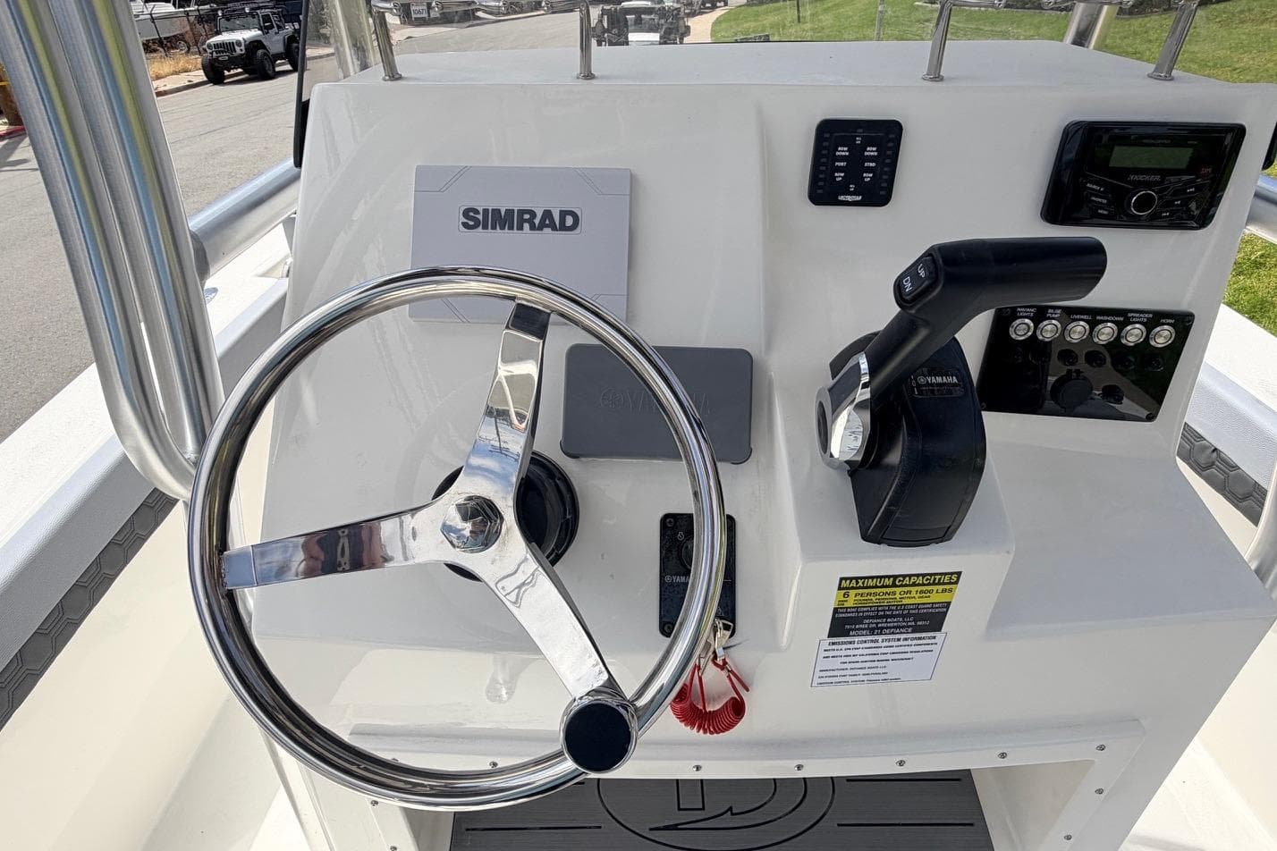 Helm of 2026 Defiance Catalina 210 boat with steering wheel and controls.