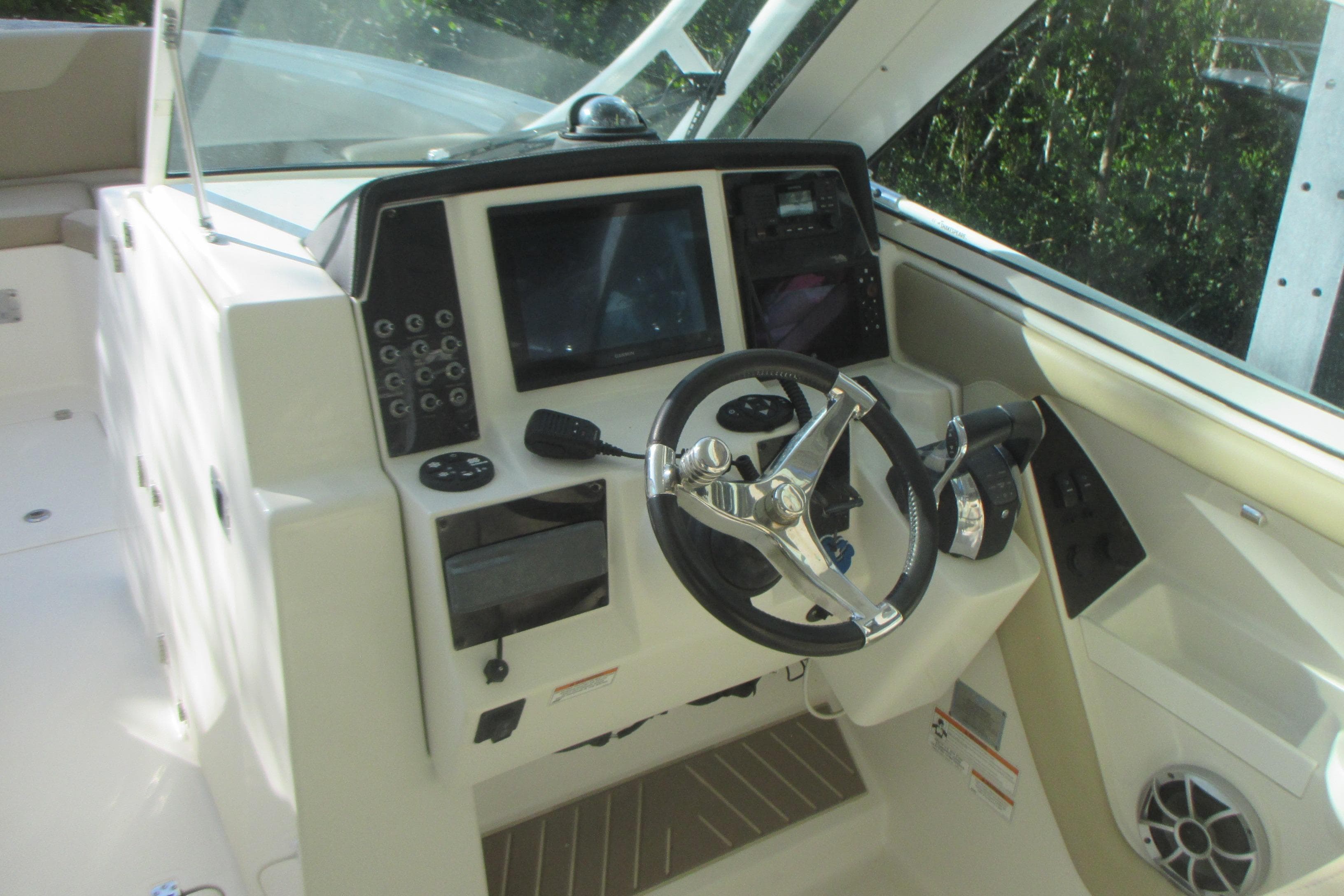 2019 Sailfish 325 DC boat cockpit with steering wheel and control panel.