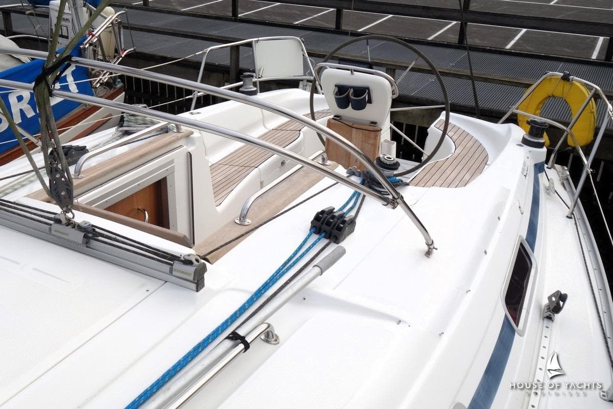 2003 Bavaria 32 sailboat deck with steering wheel and rigging details.
