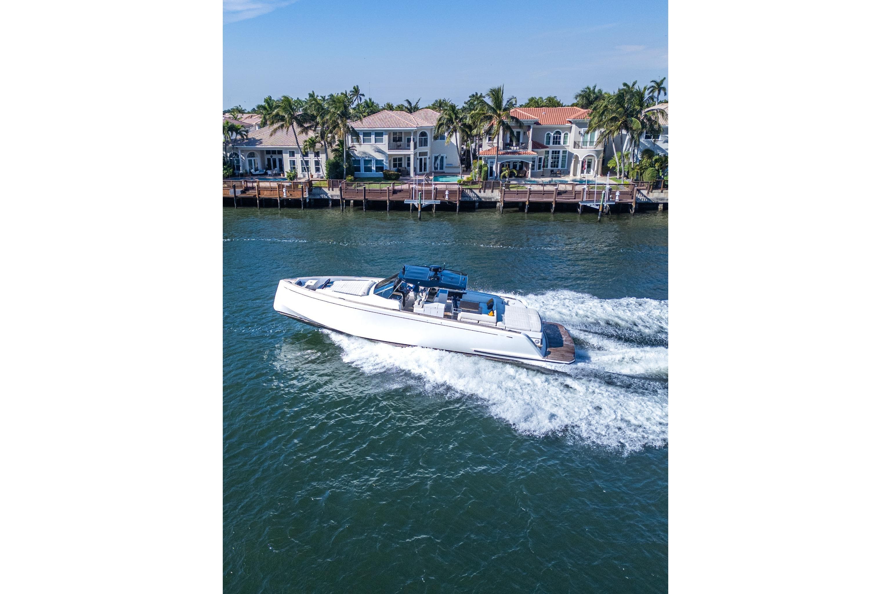 2019 Pardo Yachts P50 cruising near waterfront homes on a sunny day.