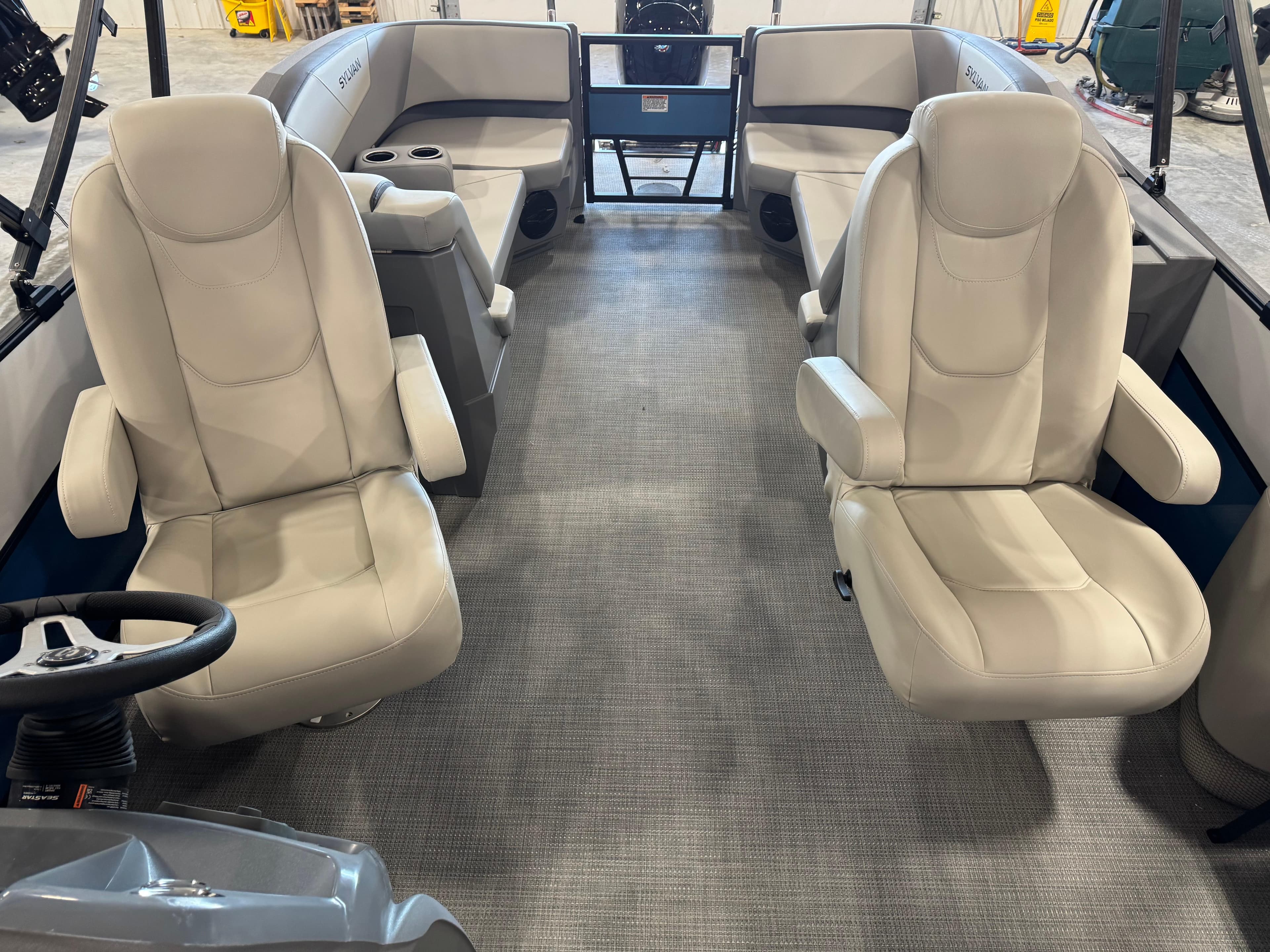 Interior of 2025 Sylvan A-22 Sport boat with beige seating and modern design.