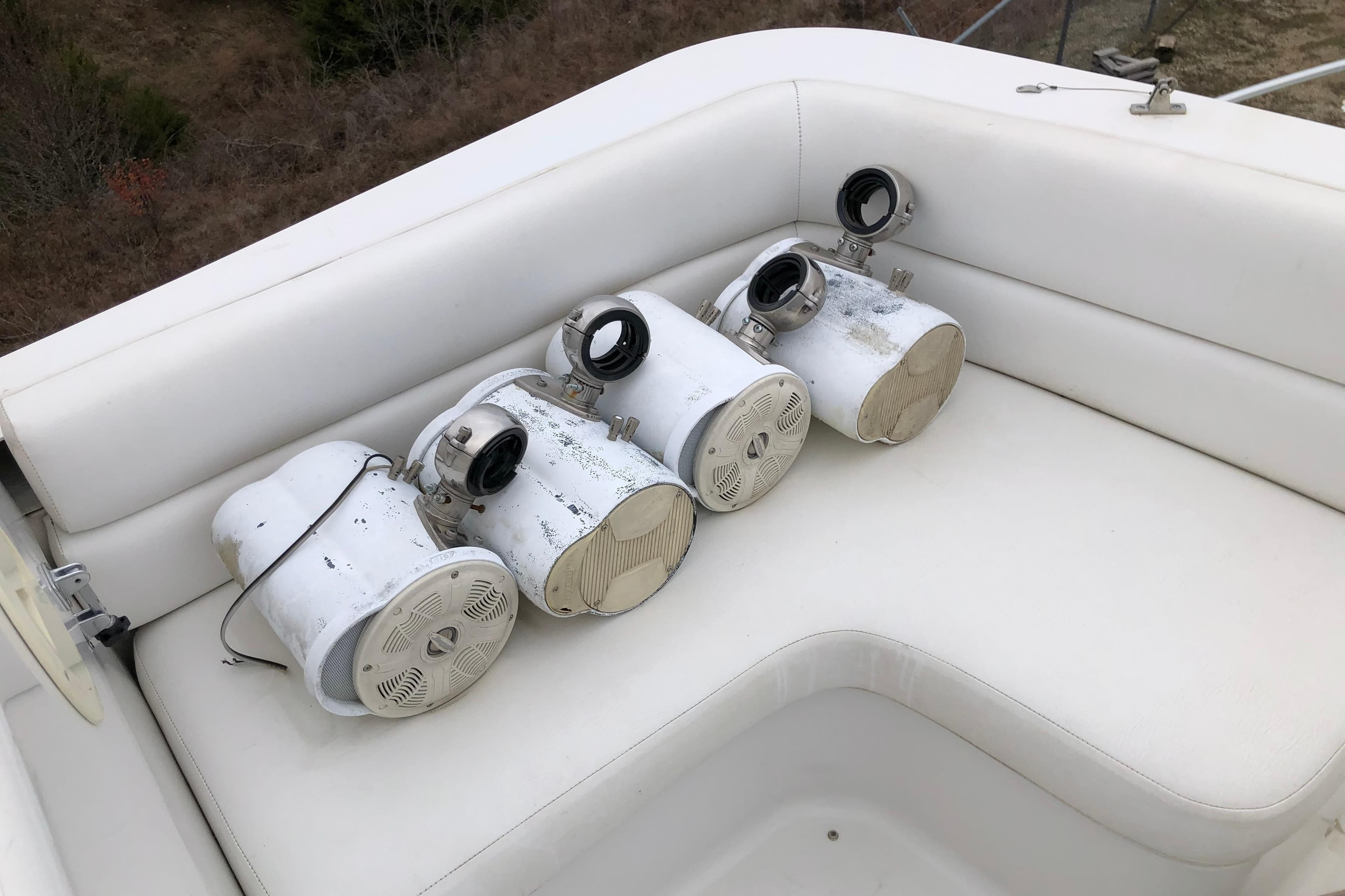 Four white marine spotlights on a 1994 Mainship 31 Sedan Bridge boat seat.