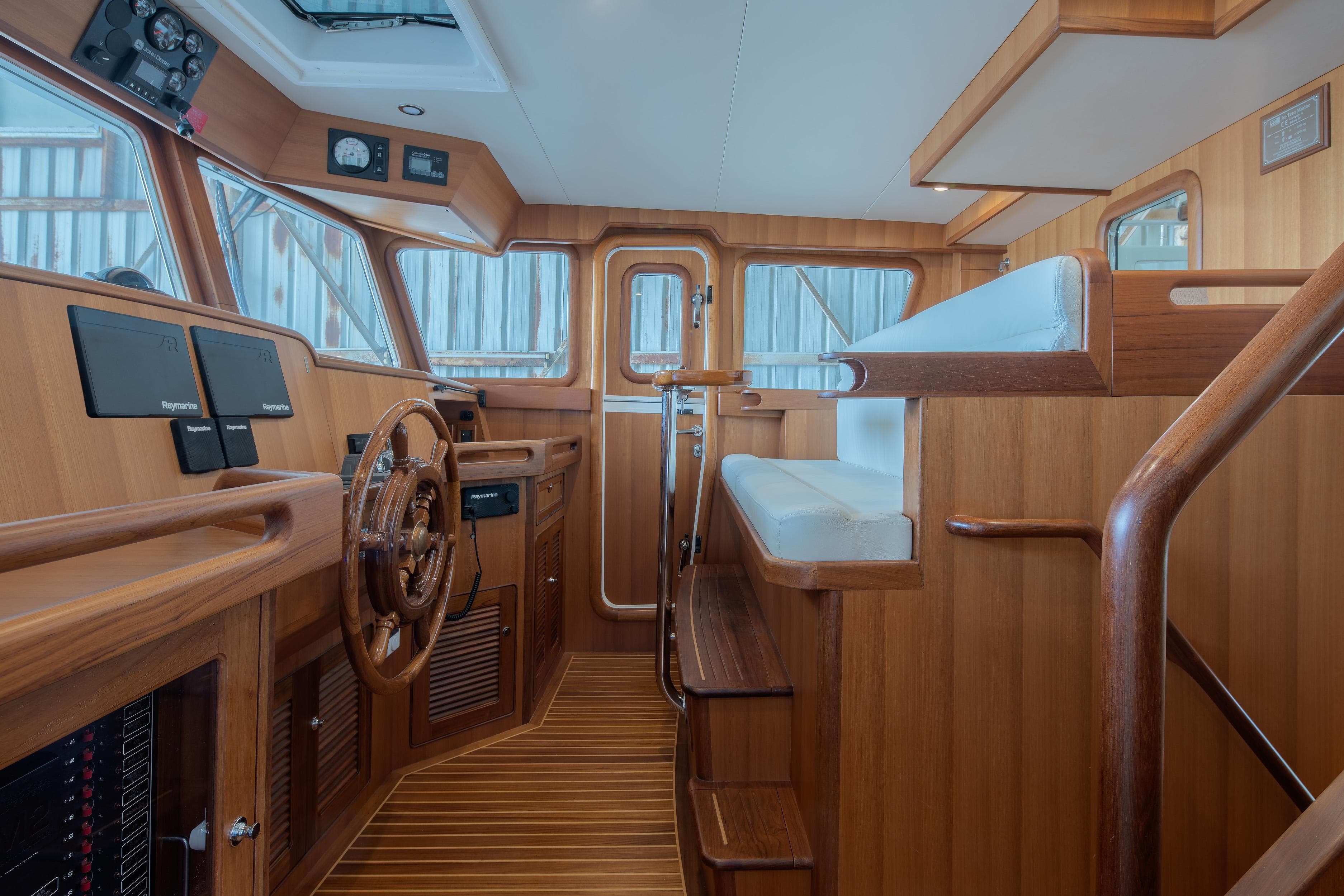 Interior of 2026 Selene 49 Classic Explorer yacht with wooden helm and seating.
