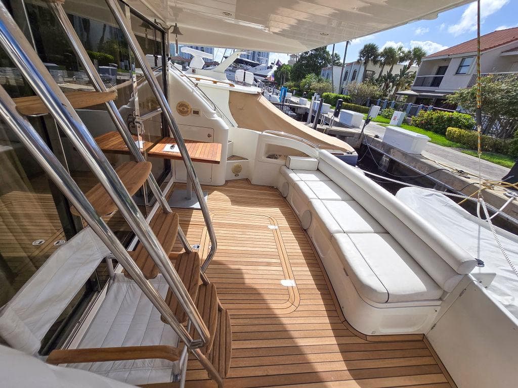 1998 Viking Princess 56 Sport Cruiser yacht with spacious deck and seating area.