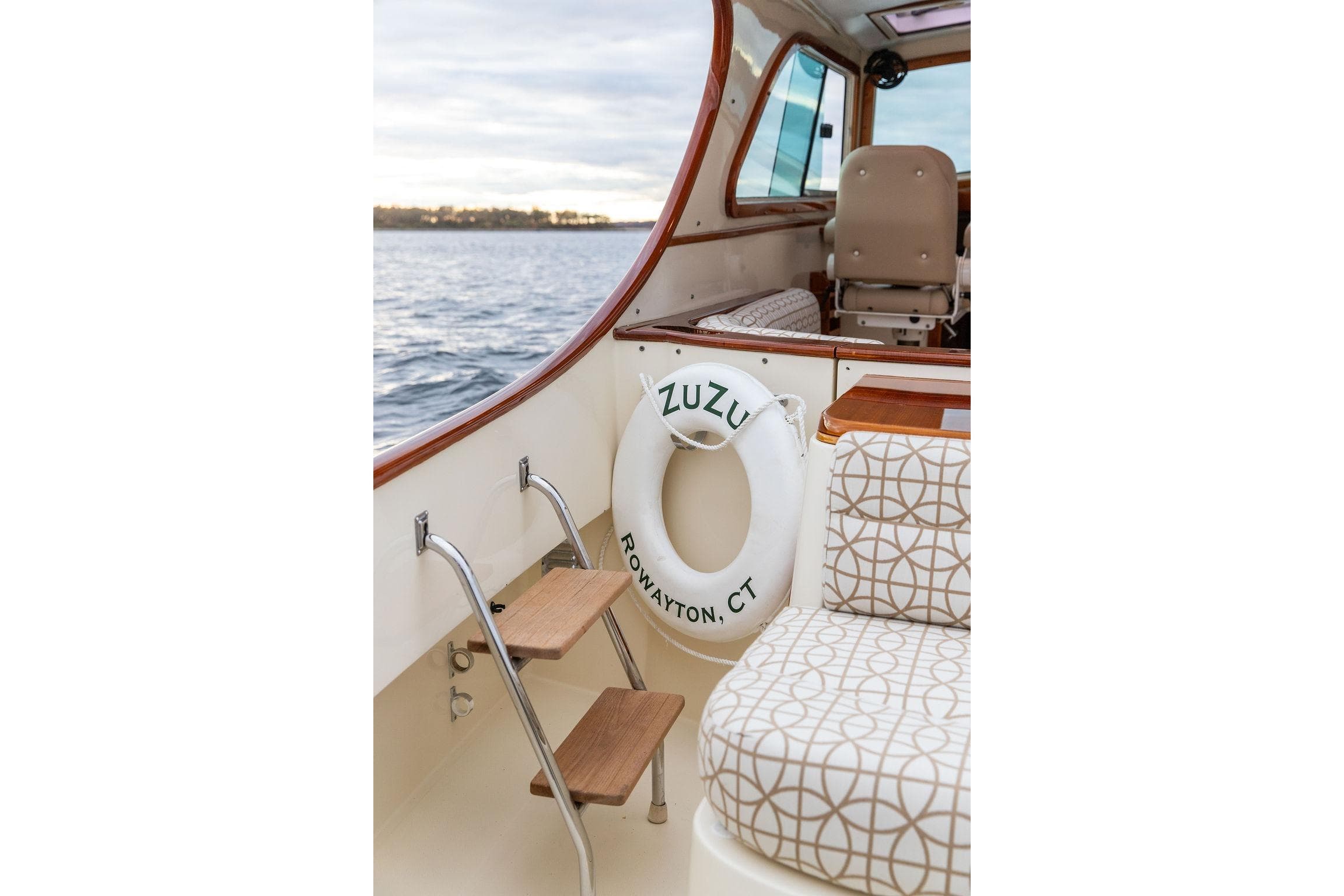 2004 Hinckley Picnic Boat EP interior with patterned seating and life preserver.