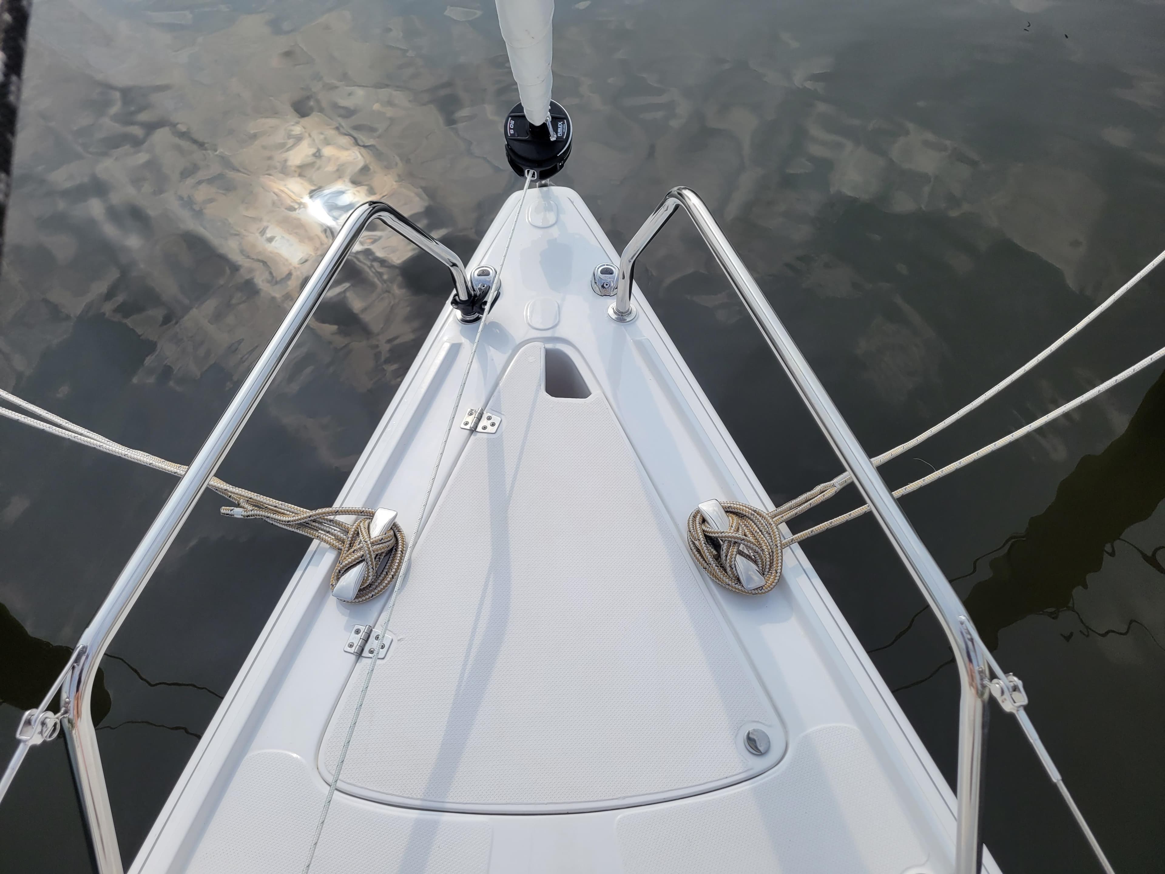 Bow of 2024 Zonda Z24 Base Model sailboat with ropes and metal railings.