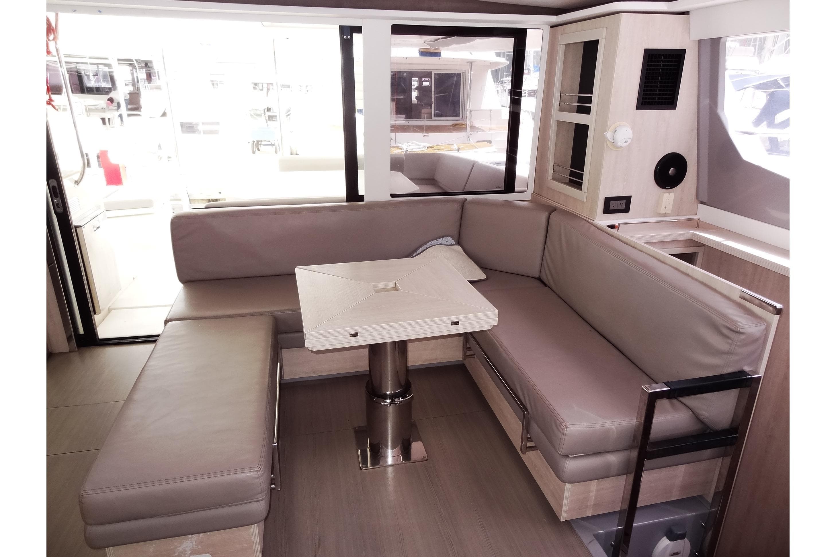 Interior of 2020 Leopard 45 yacht with modern seating and table arrangement.