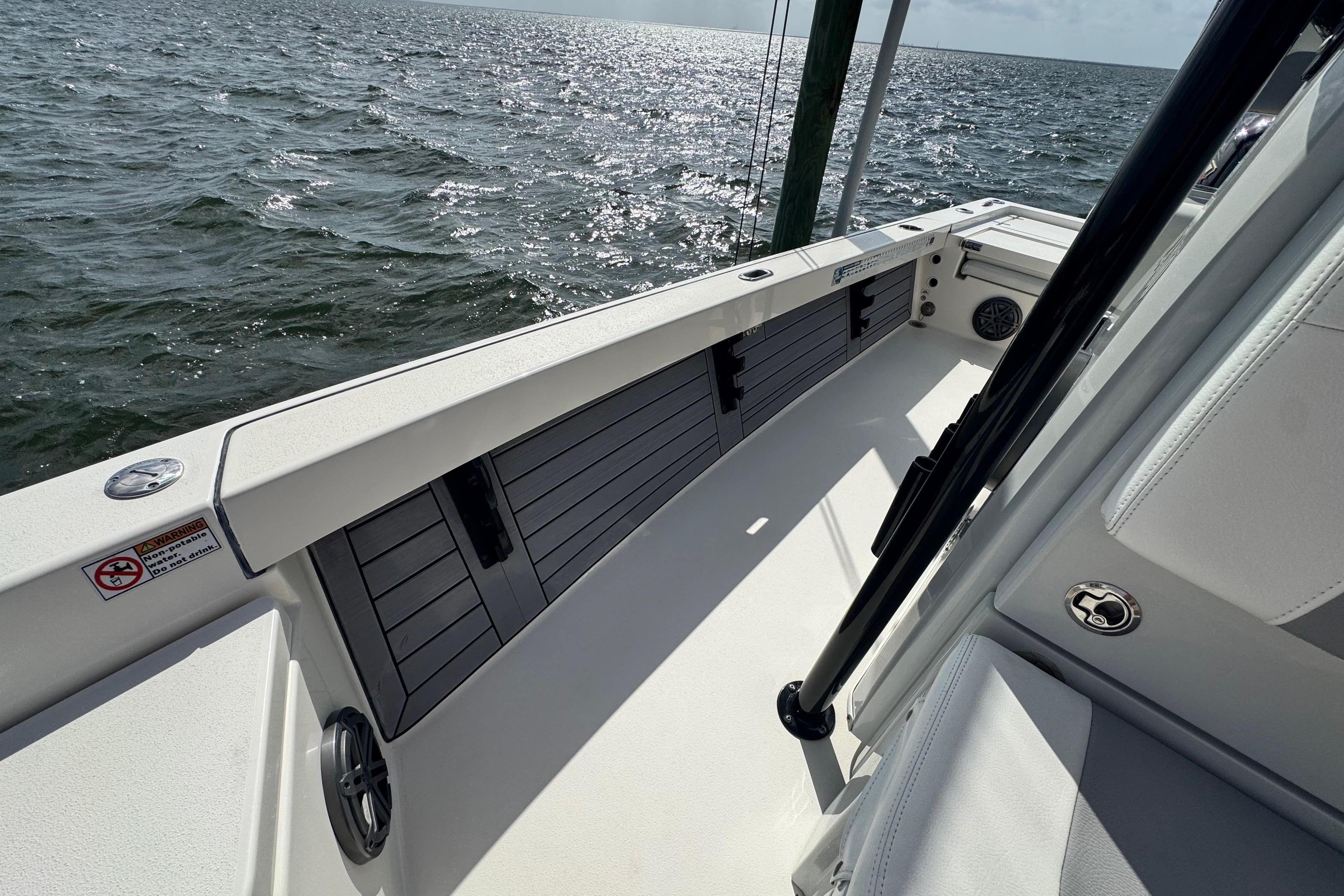 2022 Pathfinder 2400 TRS boat interior with ocean view, showcasing sleek design and storage compartments.