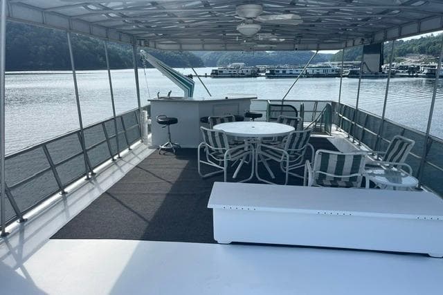 1992 Lakeview houseboat deck with seating, bar, and scenic lake view.