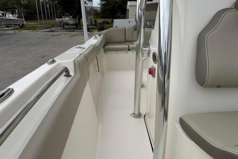 2024 Key West 203 FS boat interior with seating and stainless steel railings.