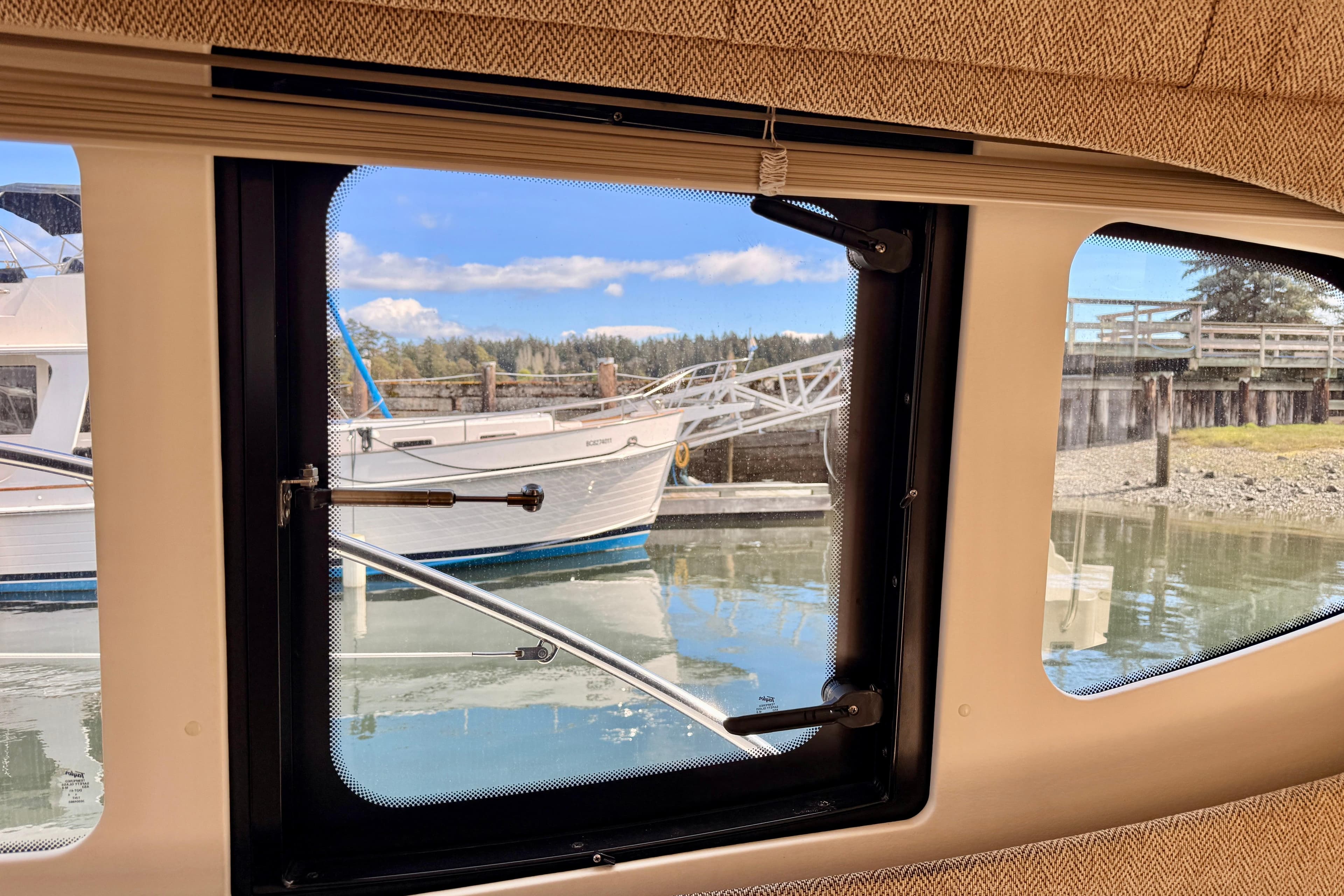 View from inside a 2005 Silverton 34 Convertible, overlooking a marina with boats.