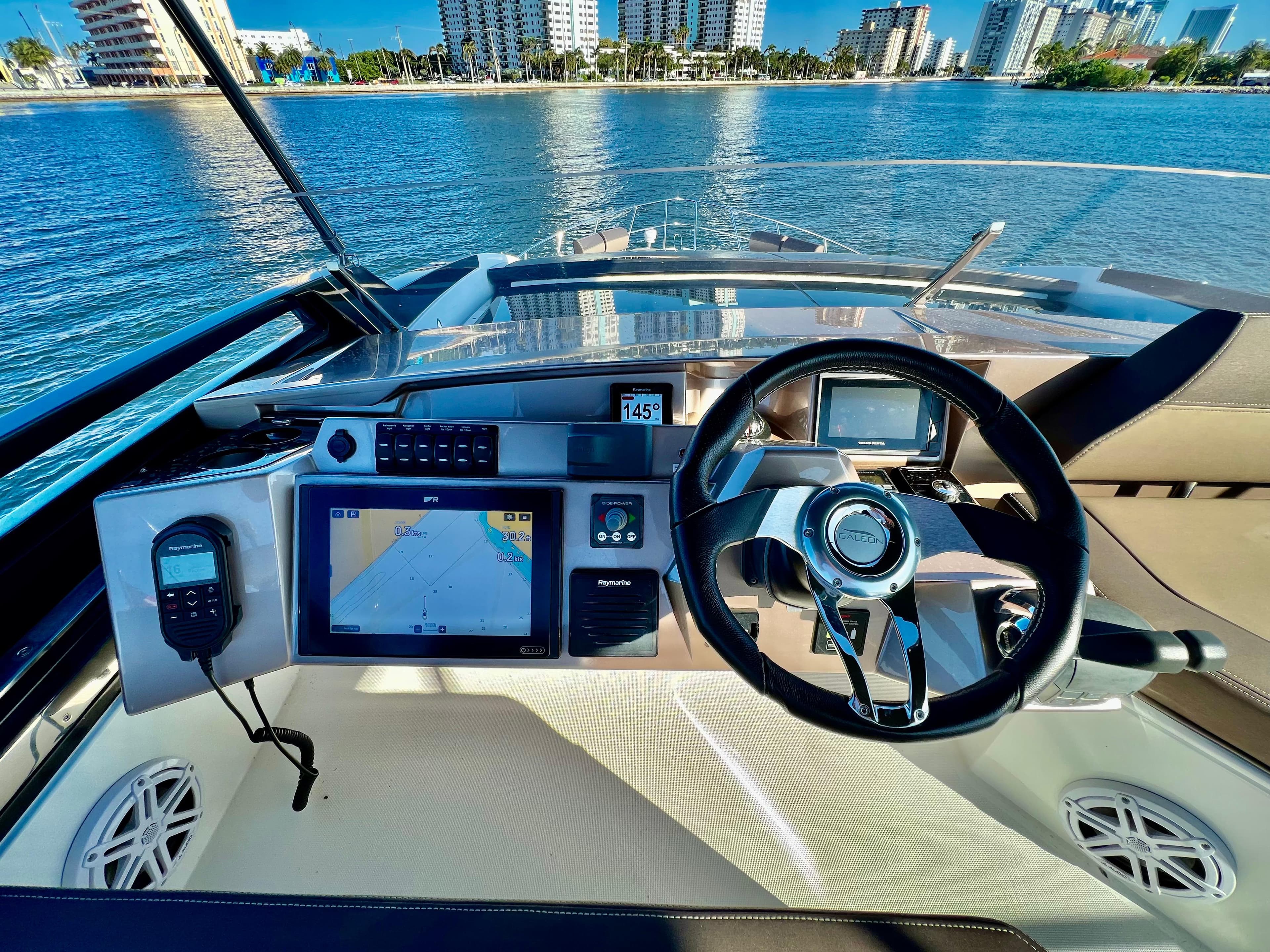 2022 Galeon 470 Sky yacht helm with navigation system and waterfront view.