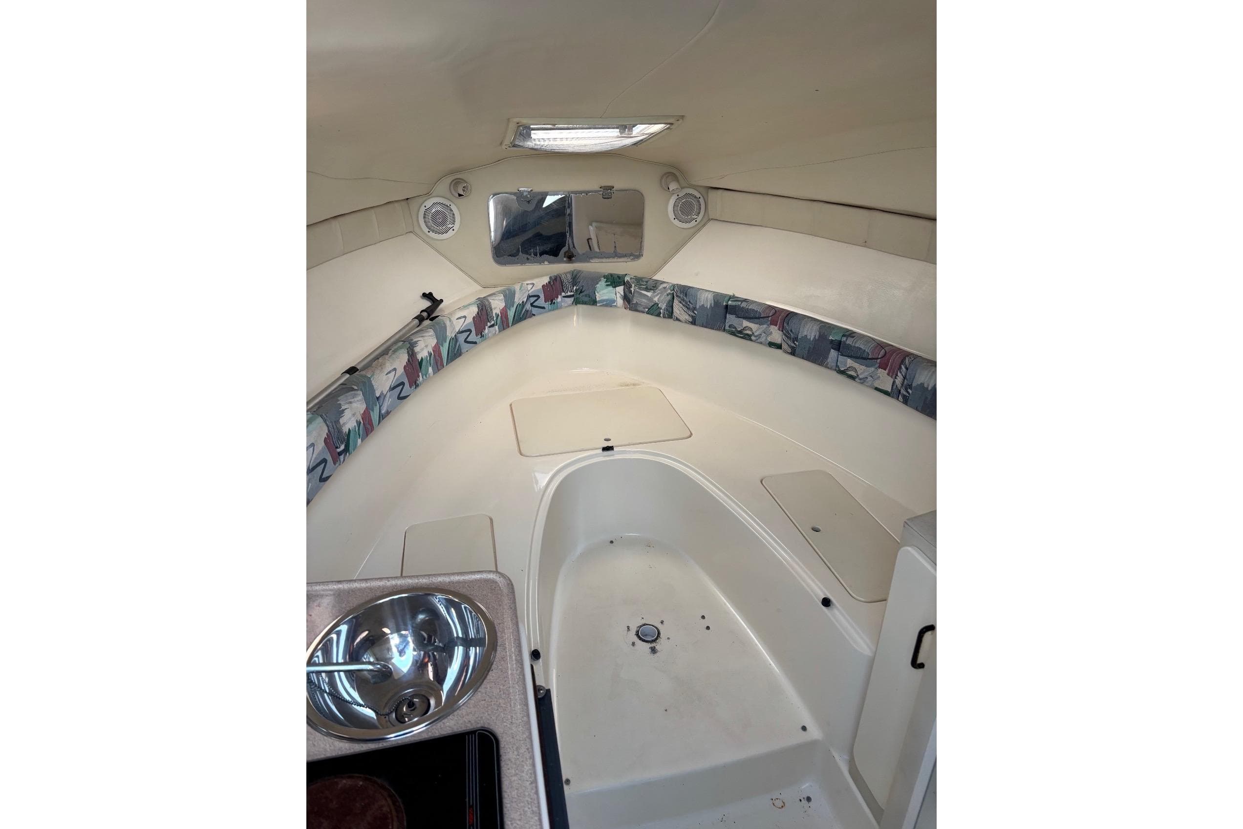 Interior of a 1997 Donzi 255 LXC boat with sink and seating area.