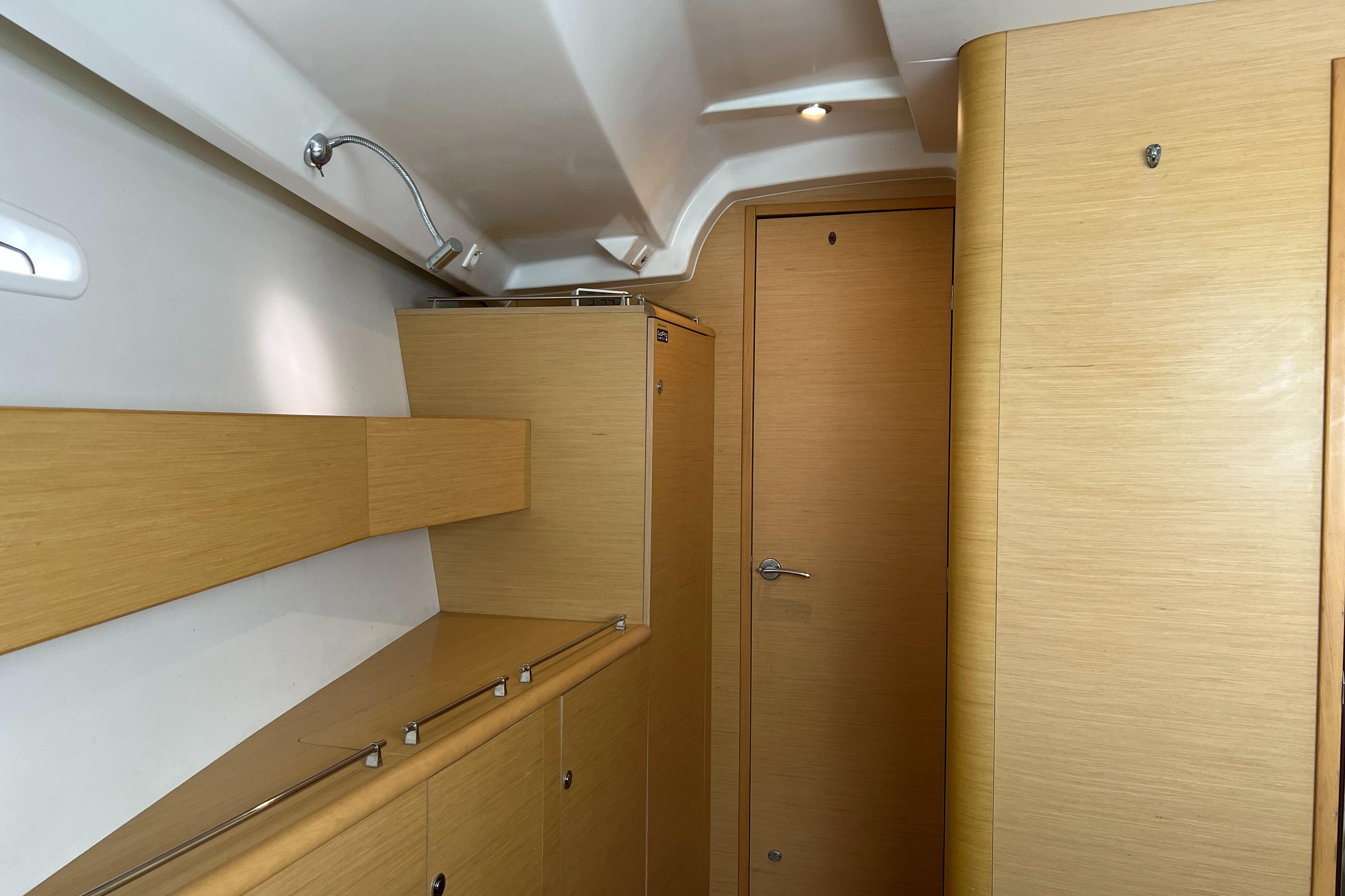 Interior of 2011 Beneteau First 50 yacht with wooden cabinetry and modern design.