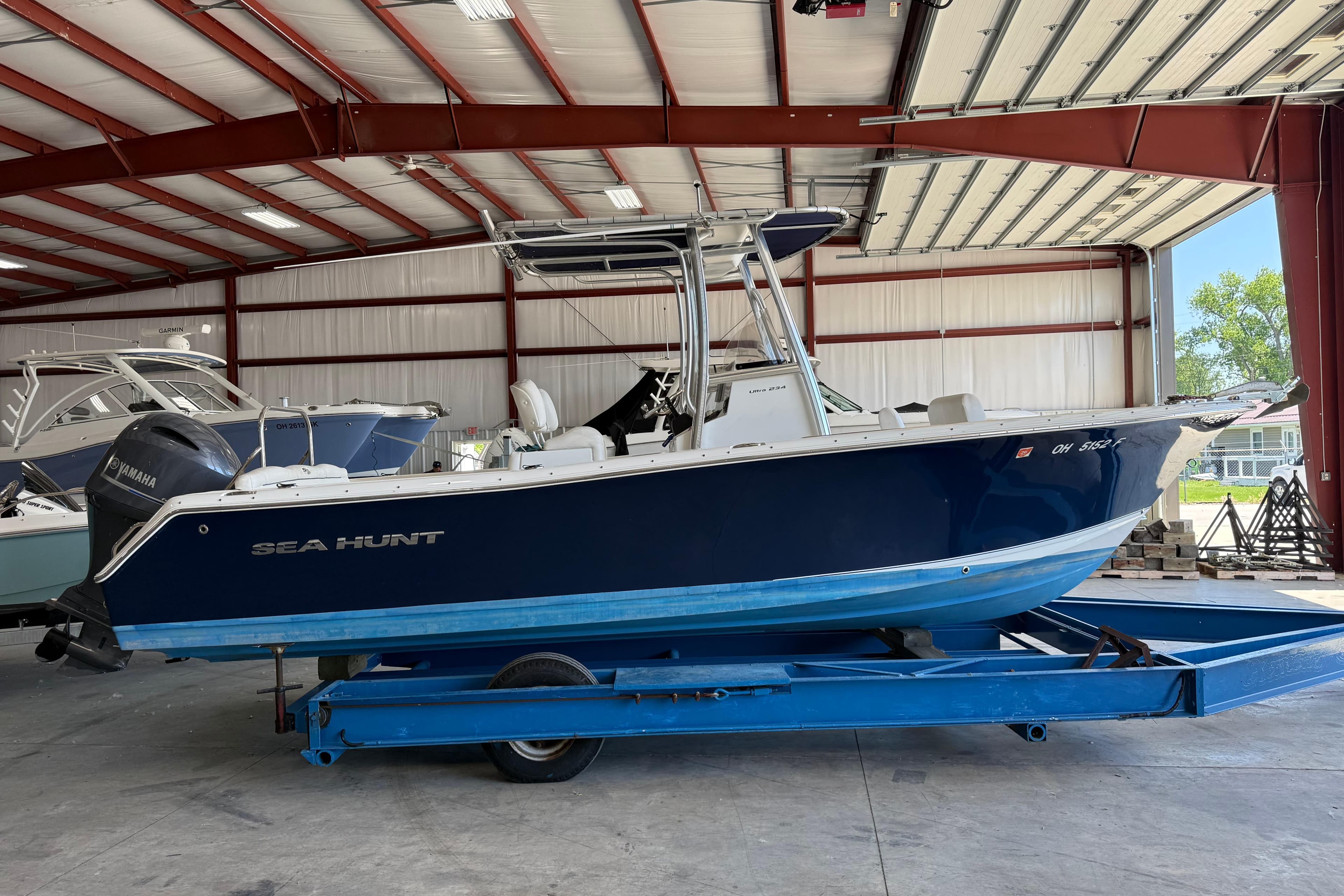2015 Sea Hunt Ultra 234 boat on trailer in indoor storage facility.