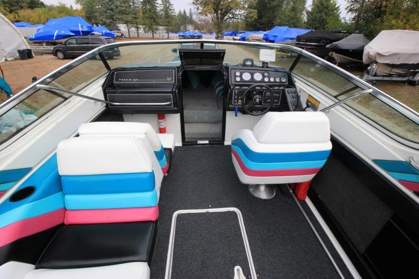 1989 Formula 223 SS boat interior with colorful seating and control panel.